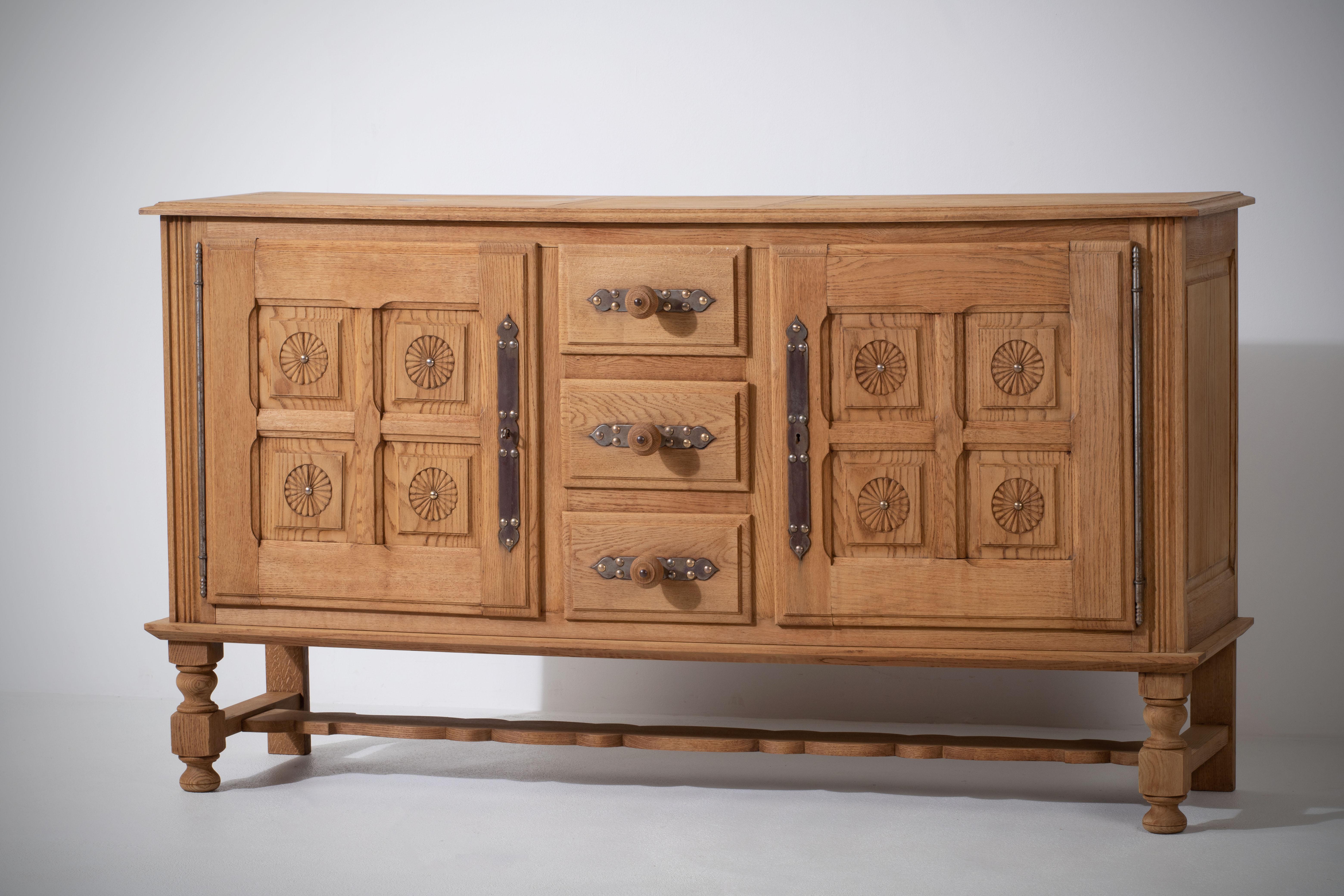 Charming 1950s Bleached Oak sideboard with Hand-Carved Daisies - A Rustic Reims Region Treasure

Introducing a truly captivating bleached oak sideboard, rich in character and history, discovered in the heart of France's Reims region. The