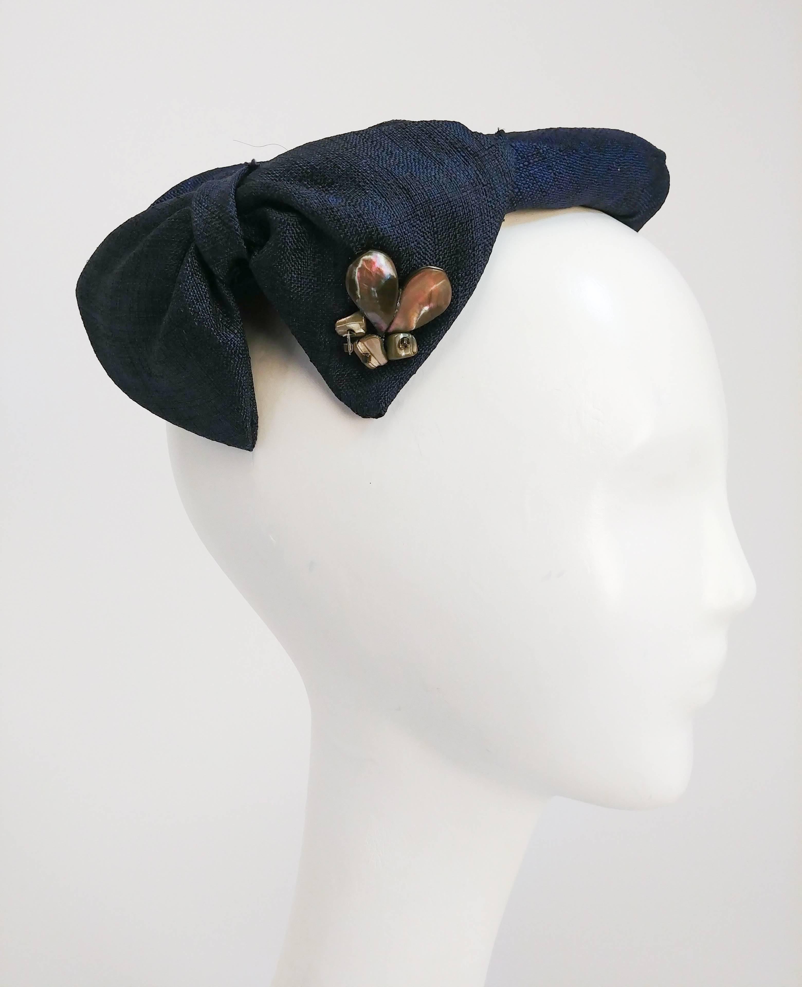 1950s Blue Cocktail Hat w/ Shell Embellishment. Blue cocktail hat featuring shell and stone embellishment, bows adorning the sides and a gather in the center of the top. Open Size.
