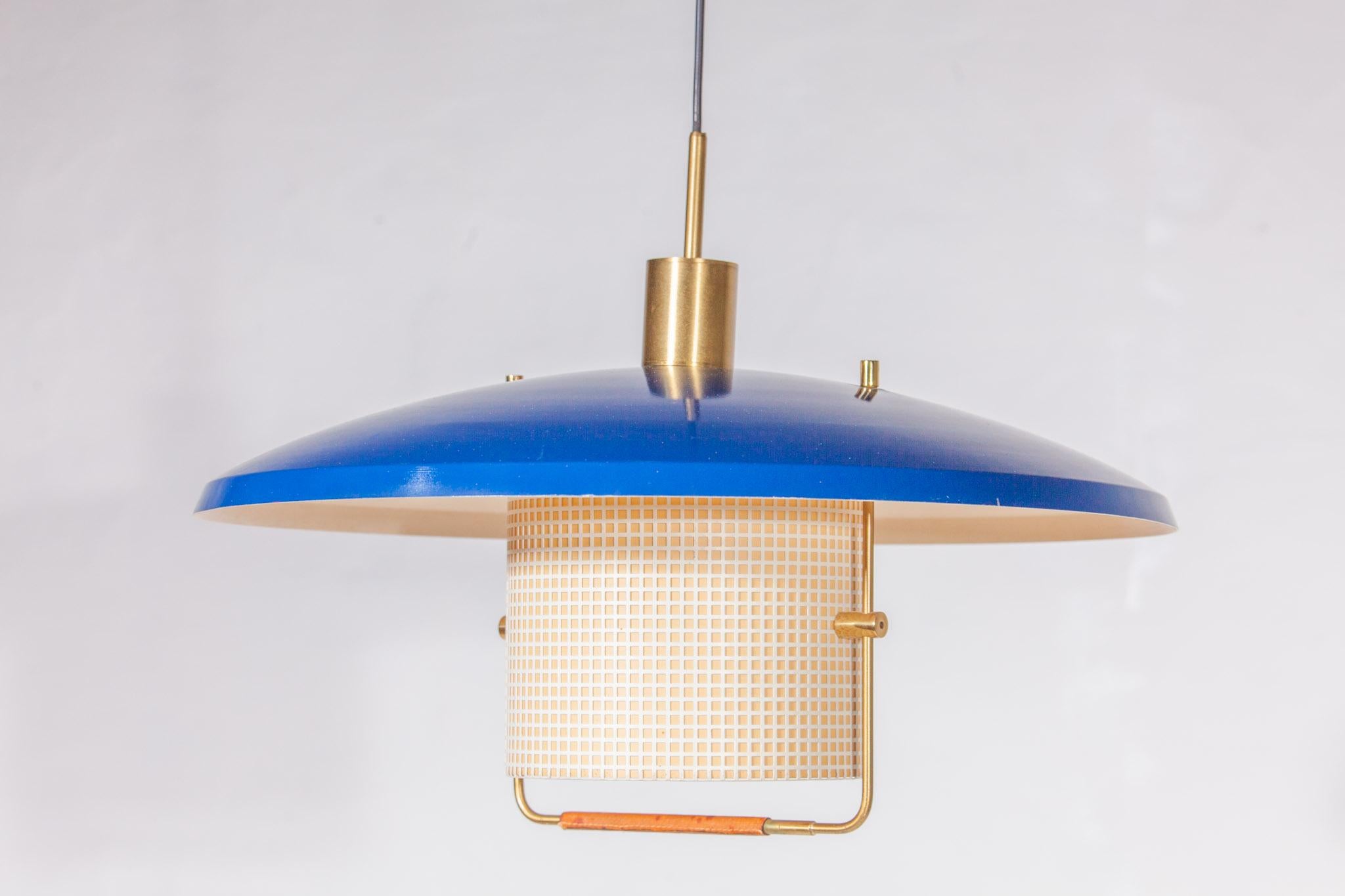 A very rare pendant in enameled metal, deep blue metal and custom brass ceiling plate, solid brass pulley. The height can be adjusted by raising or lowering the counter weight and easy to operate by pulling the aesthetically beautiful design handle.