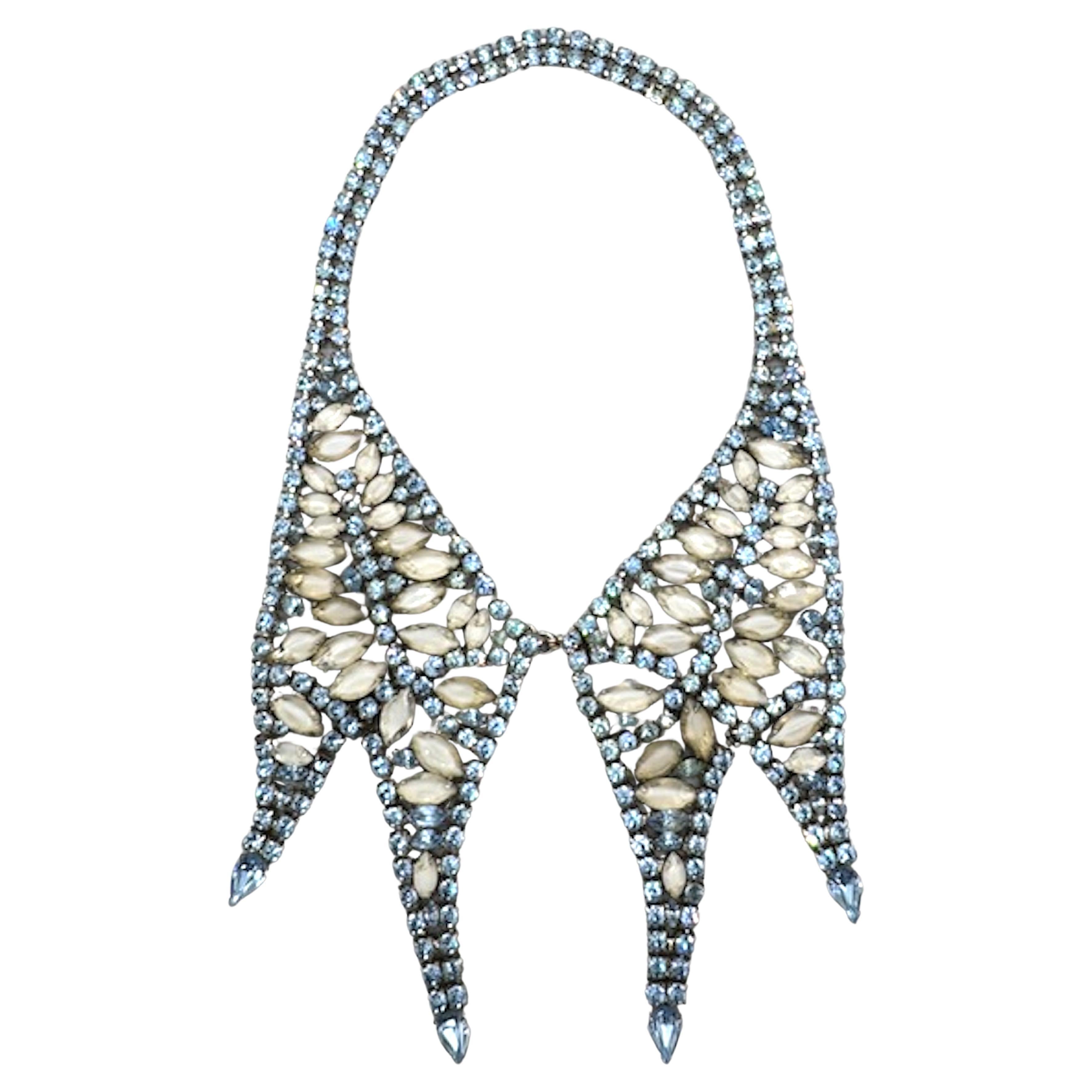 This stunning piece is a 1950s vintage rhinestone bib necklace, showcasing the dramatic flair and elegance typical of mid-century costume jewelry. It is a striking example of the glamorous costume jewelry popular in post-war fashion and Hollywood