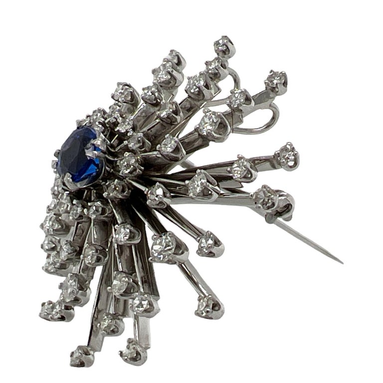 1950's sapphire and diamond Spray pin handcrafted in 14 karat white gold. The brooch features a mix of 60 round brilliant, Old European, and single cut diamonds weighing approximately 2.50 carat total weight. The diamonds are graded H-I color and SI