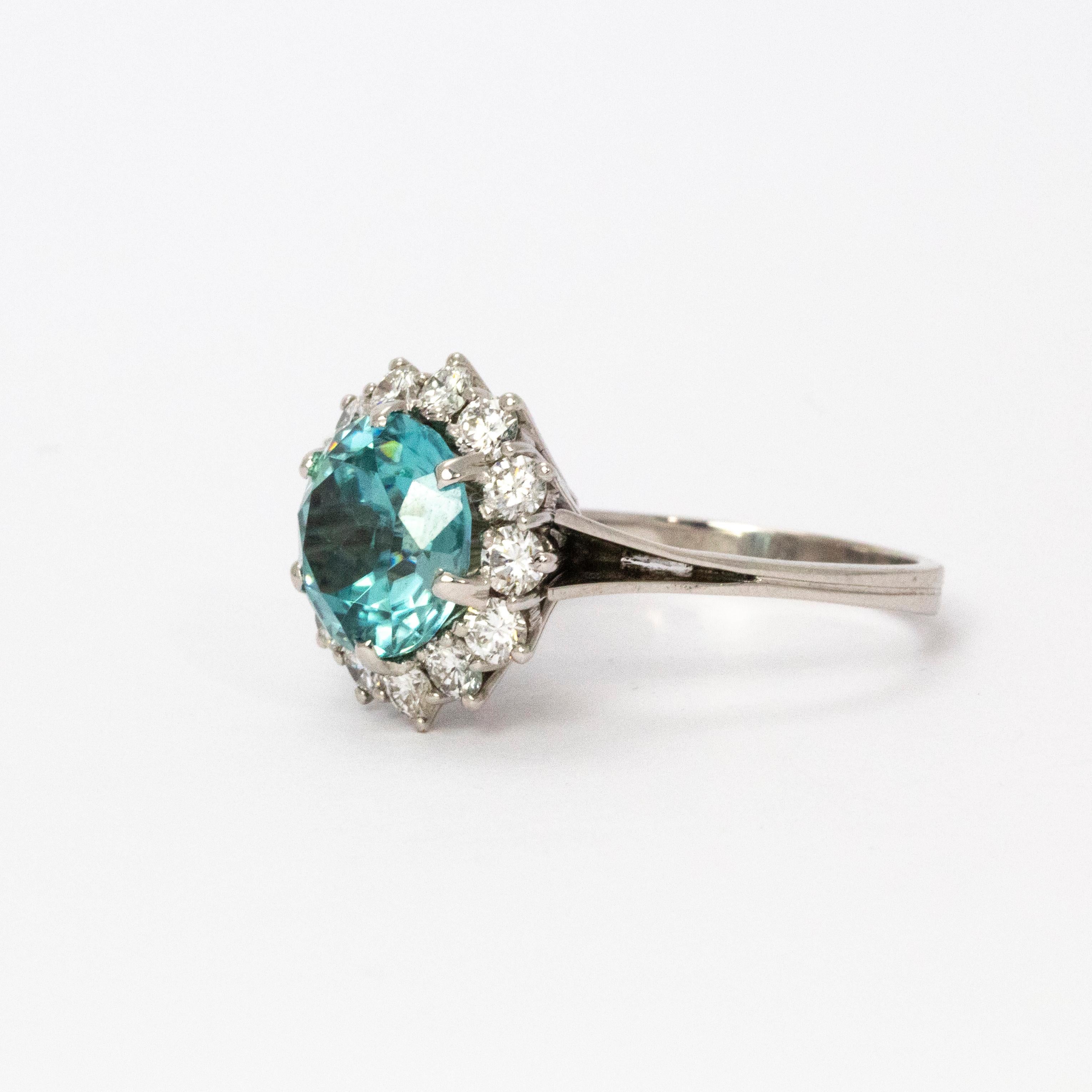 A stunning 1950s cocktail ring. Centrally set with a fantastic blue zircon measuring approximately 3.5 carats, surrounded by a halo of wonderful white brilliant cut diamonds measuring approximately 10 points each, F colour and VVS1 clarity. Total