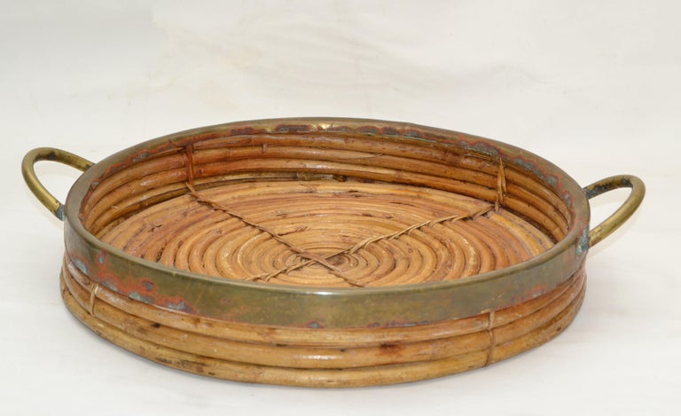 1950s vintage boho chic handcrafted bamboo wood table tray with Brass Border and 2 handles.
It is easy to carry around your home, holding a variety of food and utensils for versatile convenience or display.
The brass can be polished for an
