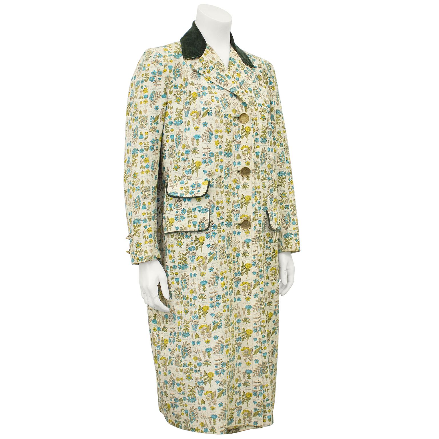 Beautiful 1950s anonymous gabardine coat with an allover print of botanical illustrations in blue, green and taupe. The notched lapel has a forest green velvet panel and the front pockets are trimmed in matching fabric. The larger top flap pockets