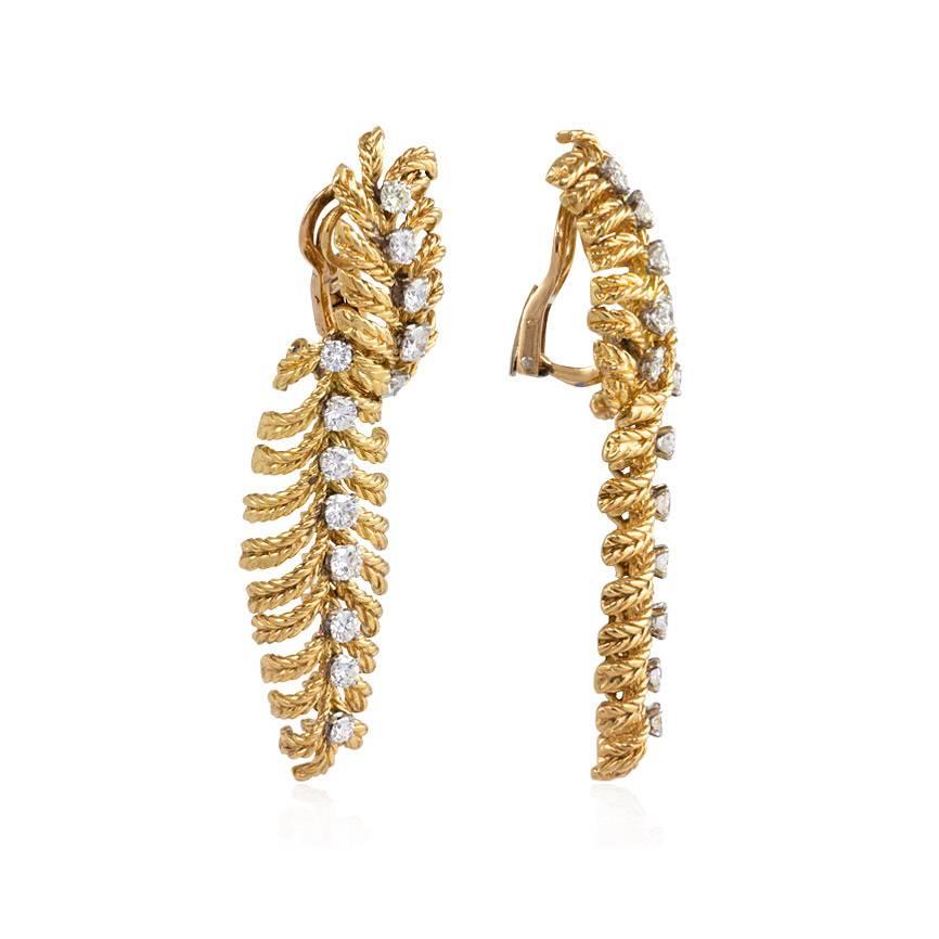 A pair of textured and articulated gold and diamond earrings of stylized plume design, in 18k and platinum.  Boucheron, Paris; #36727