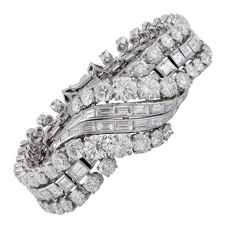 A Very Fine Platinum & Diamond Bracelet by Boucheron, French circa 1950, Claw & channel-set at the centre with a line of graduated brilliant-cut & baguette diamonds, flanked on either side by a similarly set tapered band, estimated total weight