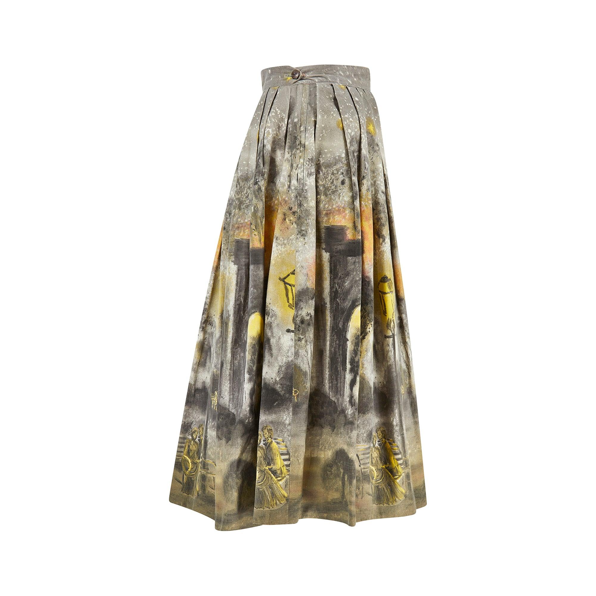 This unusual cotton skirt was manufactured in the 1950s by 'Lady Anne' and is tailored to a full-skirted, pleated style typical of this era. The skirt has the illusion of being hand-painted with a playful novelty print of a night time scene; we see