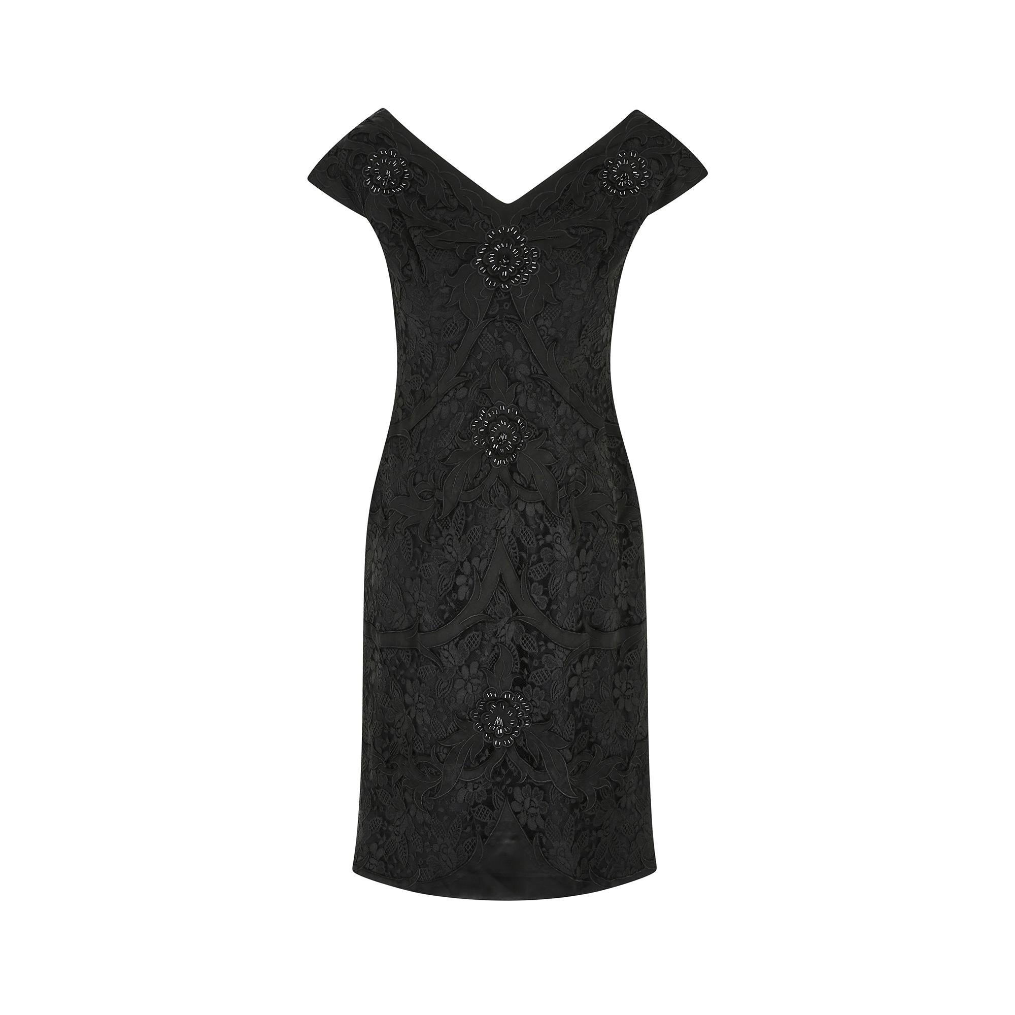 British high-end label Bramel designed this dress in the 1950s or very early 1960s. A graceful V-neckline and wide shoulders at the front and back is highly flattering.  Black lace sits under tonal satin appliquéd botanical forms and pretty beaded