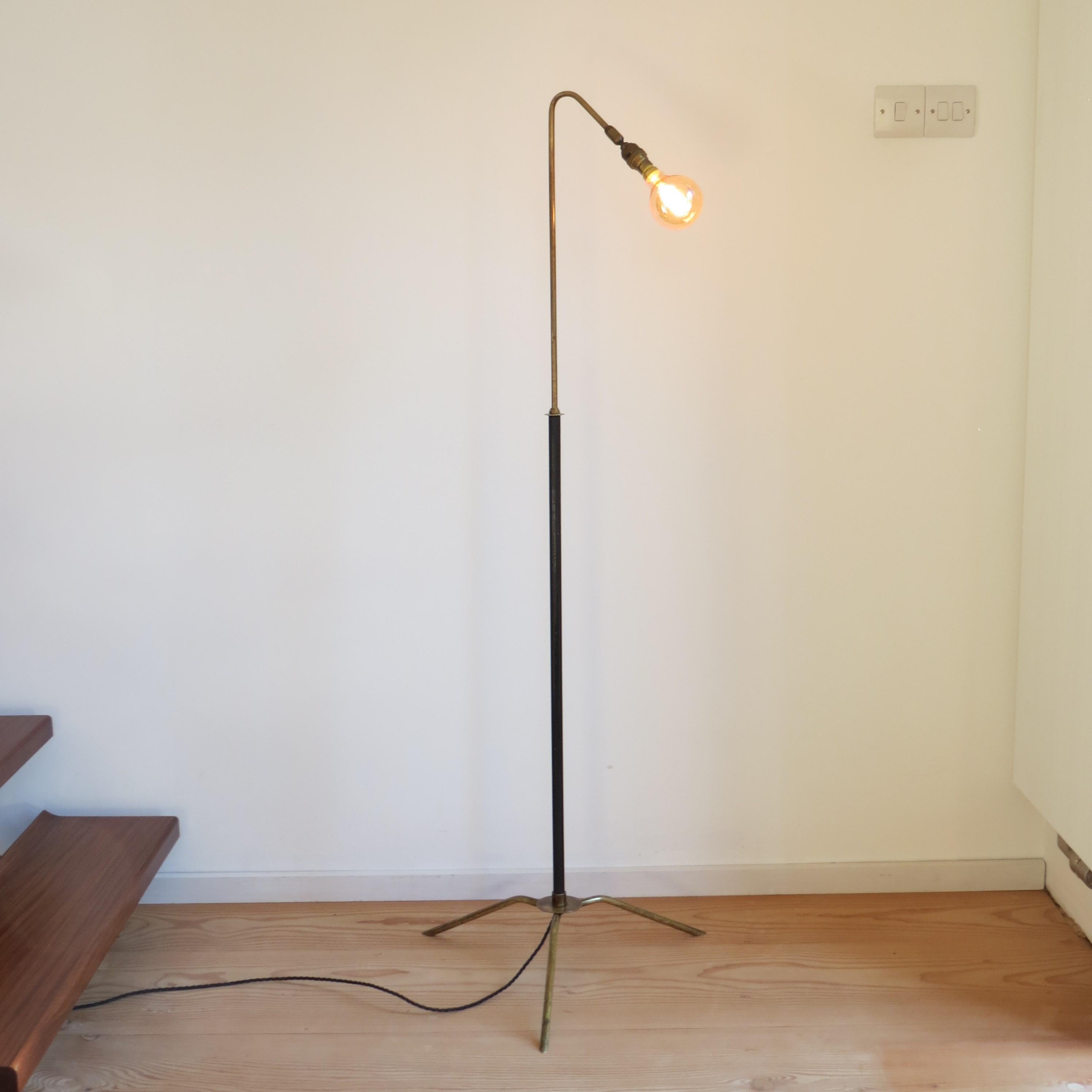 Wonderful 1950s adjustable Industrial style floor lamp.
Stylish brass legs with black metal upright and adjustable curve over brass neck. The lamp is adjustable and the brass curved neck can be extended to vary the height. The height varies from
