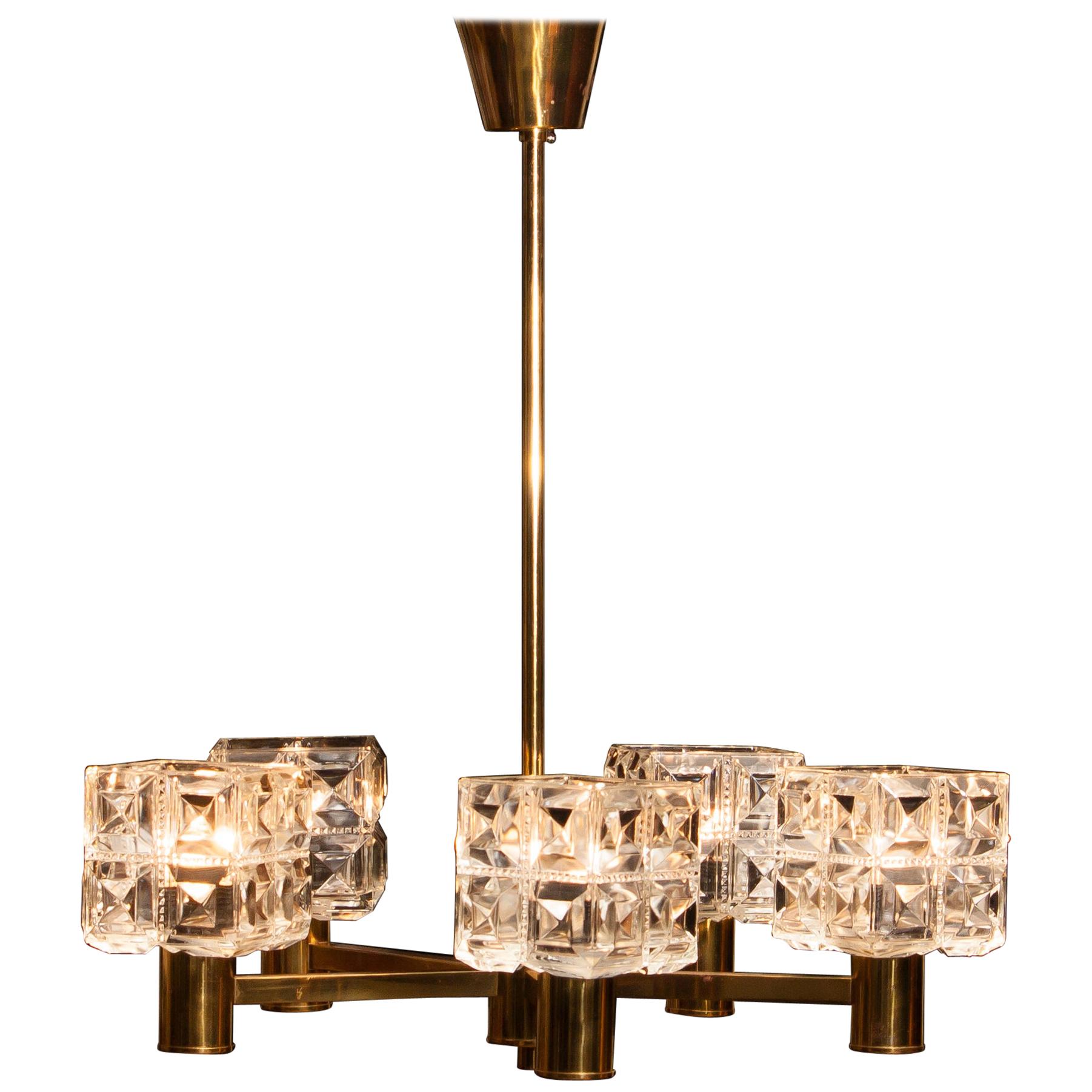 Beautiful chandelier made by Tyringe Konsthantverk, Sweden.
This lamp is made of five brass arms with crystal shades.
It is in good condition.
Period 1950s.
Dimensions: H 66 cm, ø 54 cm.
 