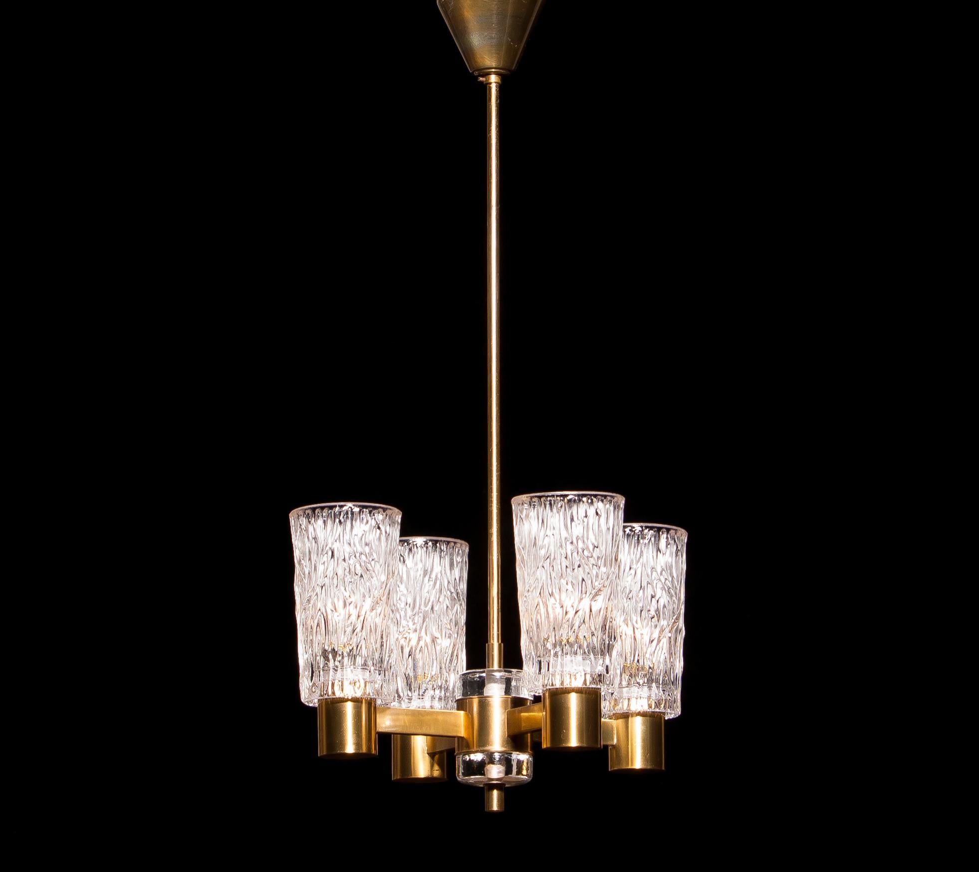 Beautiful chandelier made by Orrefors, Sweden.
This lamp is made of brass with four clear crystal glass shades.
It is in a lovely condition.
Period: 1950s.
Dimensions: H 65 cm, ø 35 cm.