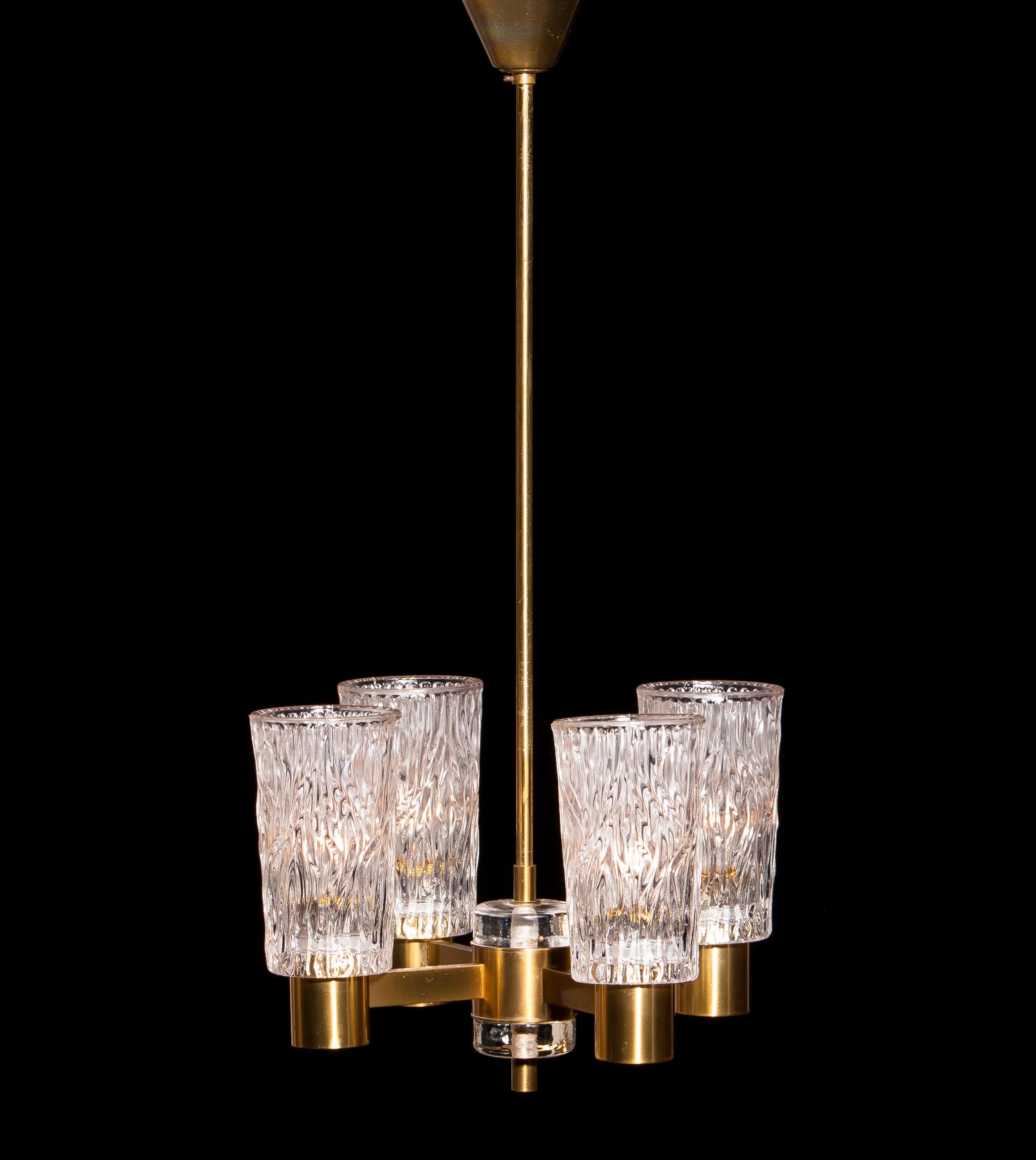 Beautiful chandelier made by Orrefors Sweden.
This lamp is made of brass with four clear crystal glass shades.
It is in a lovely condition.
Period 1950s.
Dimensions: H 65 cm, ø 35 cm.