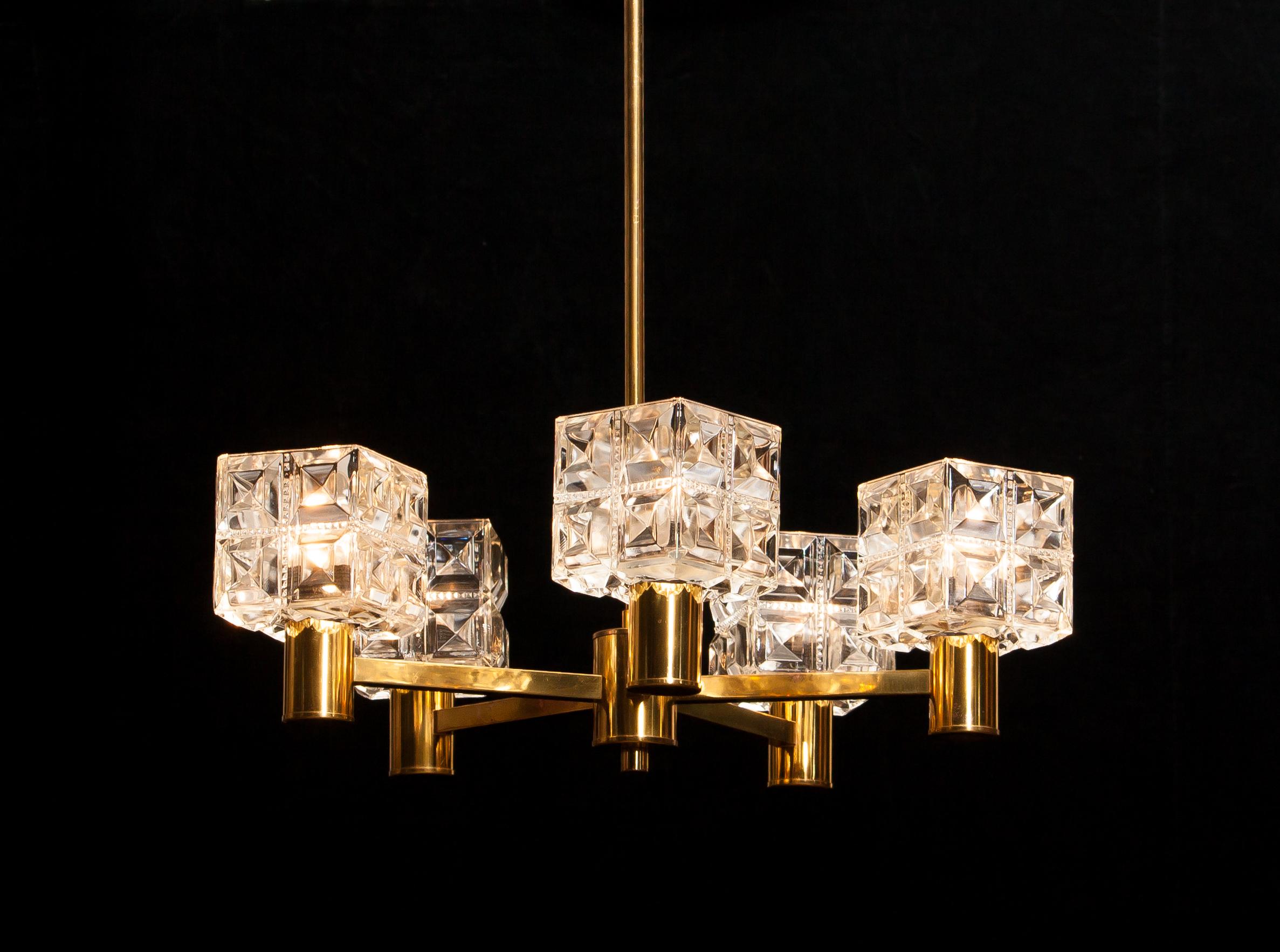 Beautiful chandelier made by Tyringe Konsthantverk, Sweden.
This lamp is made of five brass arms with glass shades.
It is in a very nice condition.
Period 1950s.
Dimensions: H 66 cm, ø 54 cm.
    