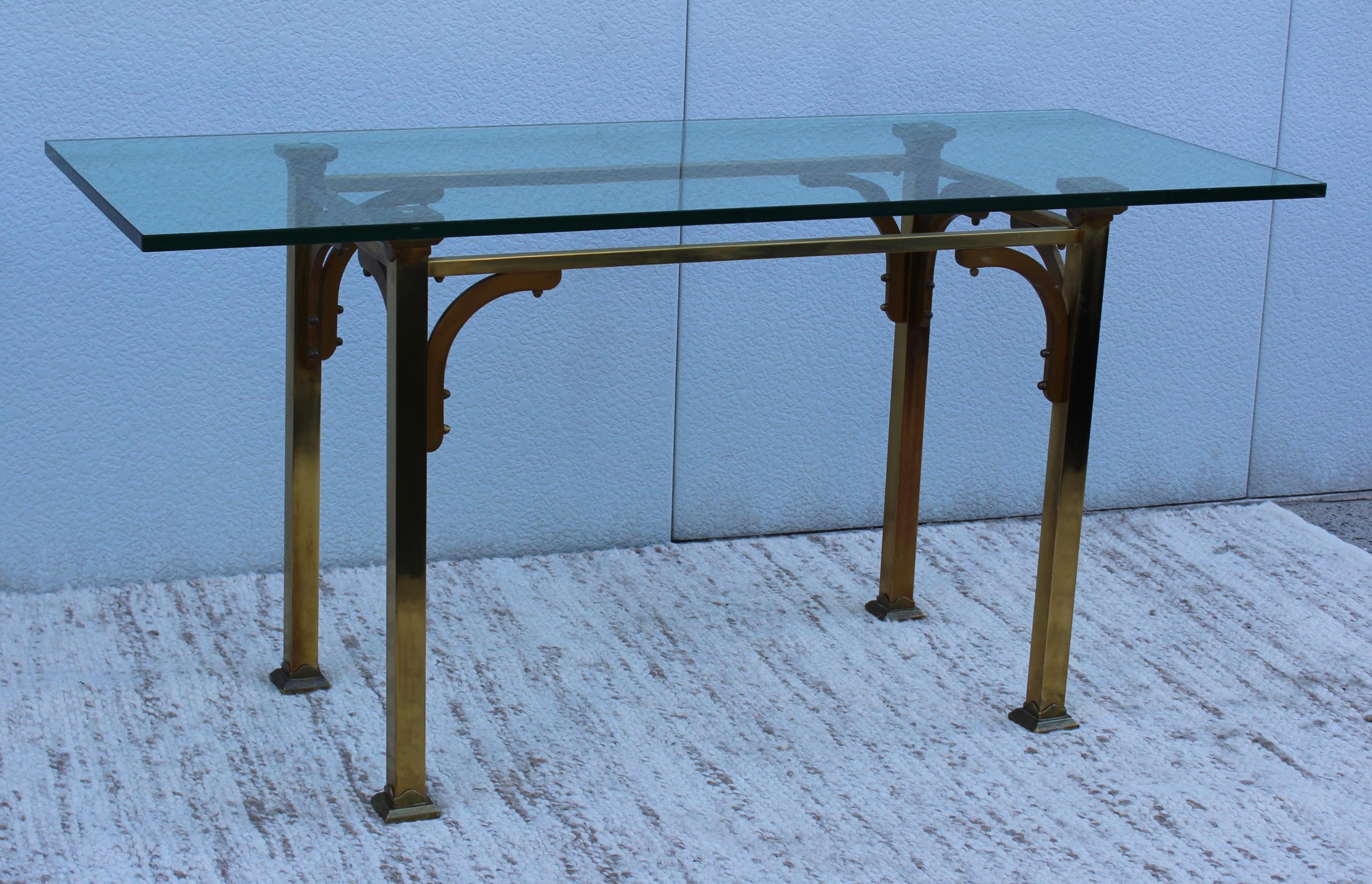 1950s brass with thick glass top console table.