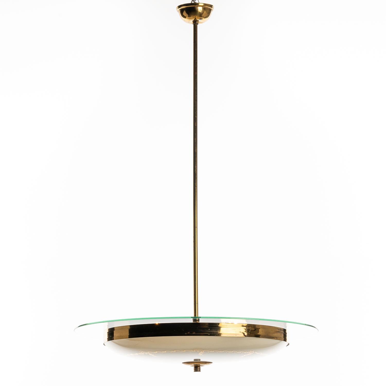 This stunning and super elegant light consisting of a brass frame and 2 unique glass reflector/saucers. 
The lower round curved glass reflector with gold patterns mounts below a larger flat clear glass reflector. A beautiful brass ring to connect
