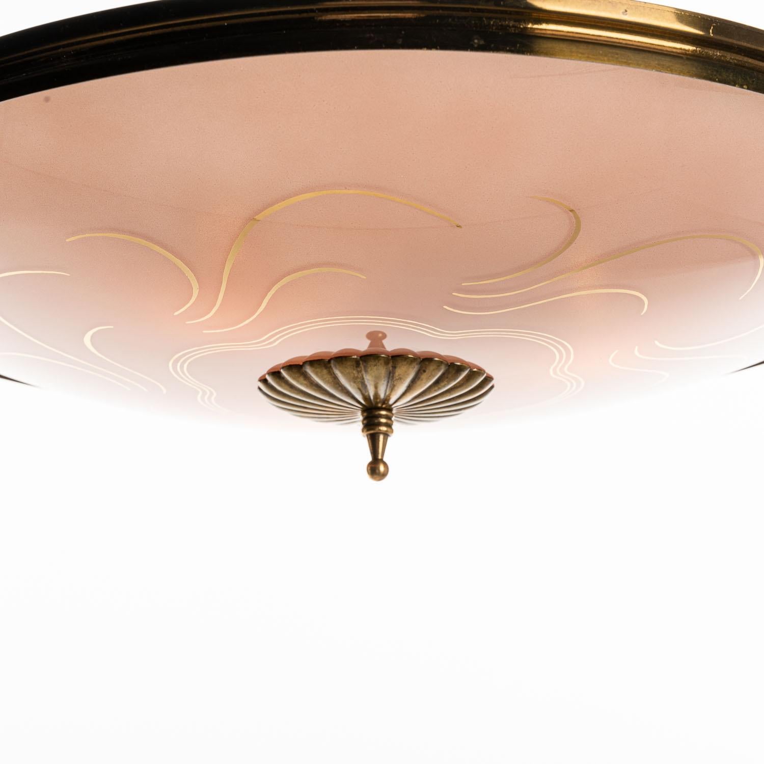 This elegant piece consisting of a brass frame and 2 unique frosted and satin glass reflector/saucers. 
The lower round curved pink-colored glass reflector with gold stripe motifs mounts below a round crystal clear glass reflector. Finished off
