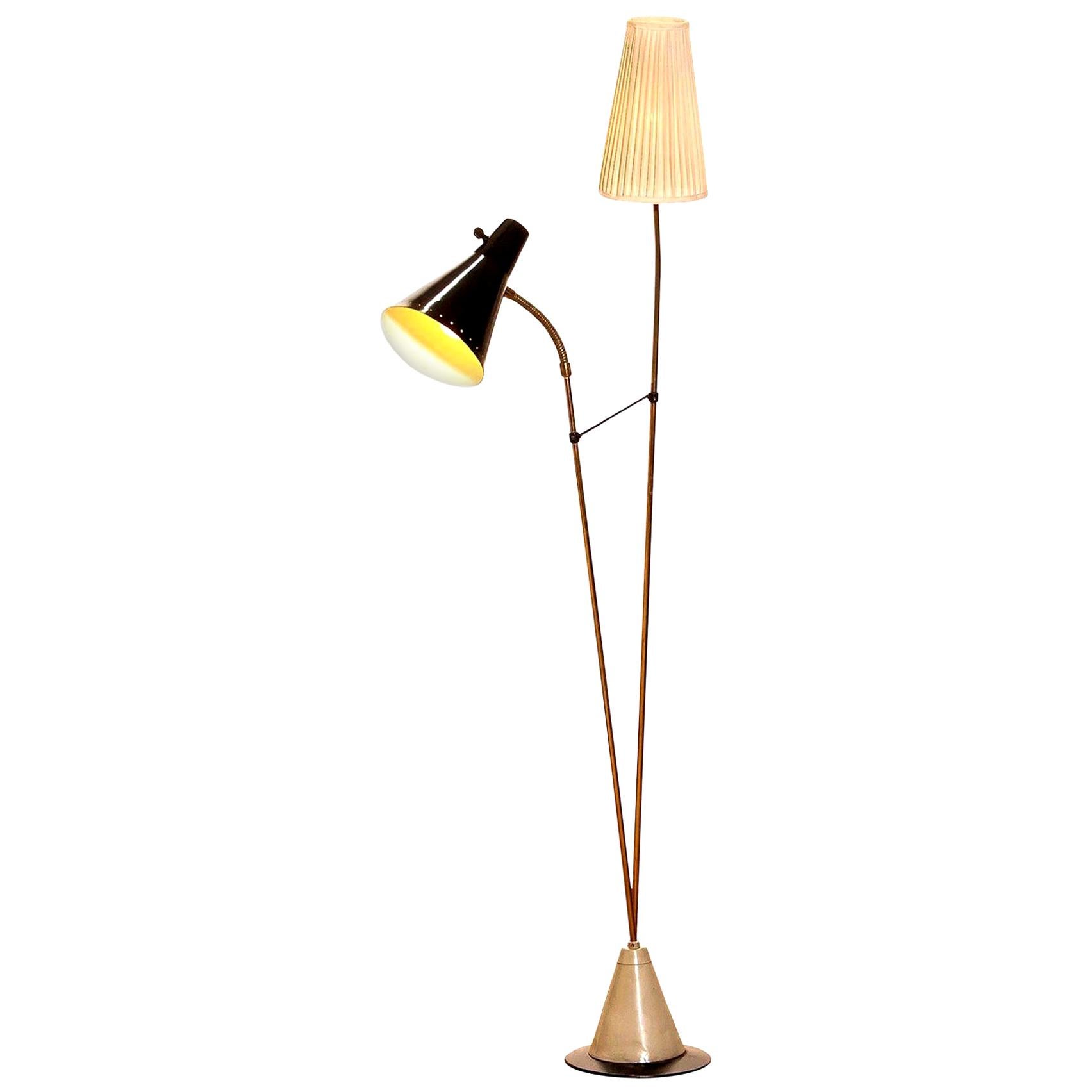 Beautiful floor lamp designed by Hans Bergström for Ateljé Lyktan, Sweden.
This lamp consists of two different shades, one black lacquered metal and one off-white in fabric. The Stand is made of brass with a beautiful iron foot. It is in a very