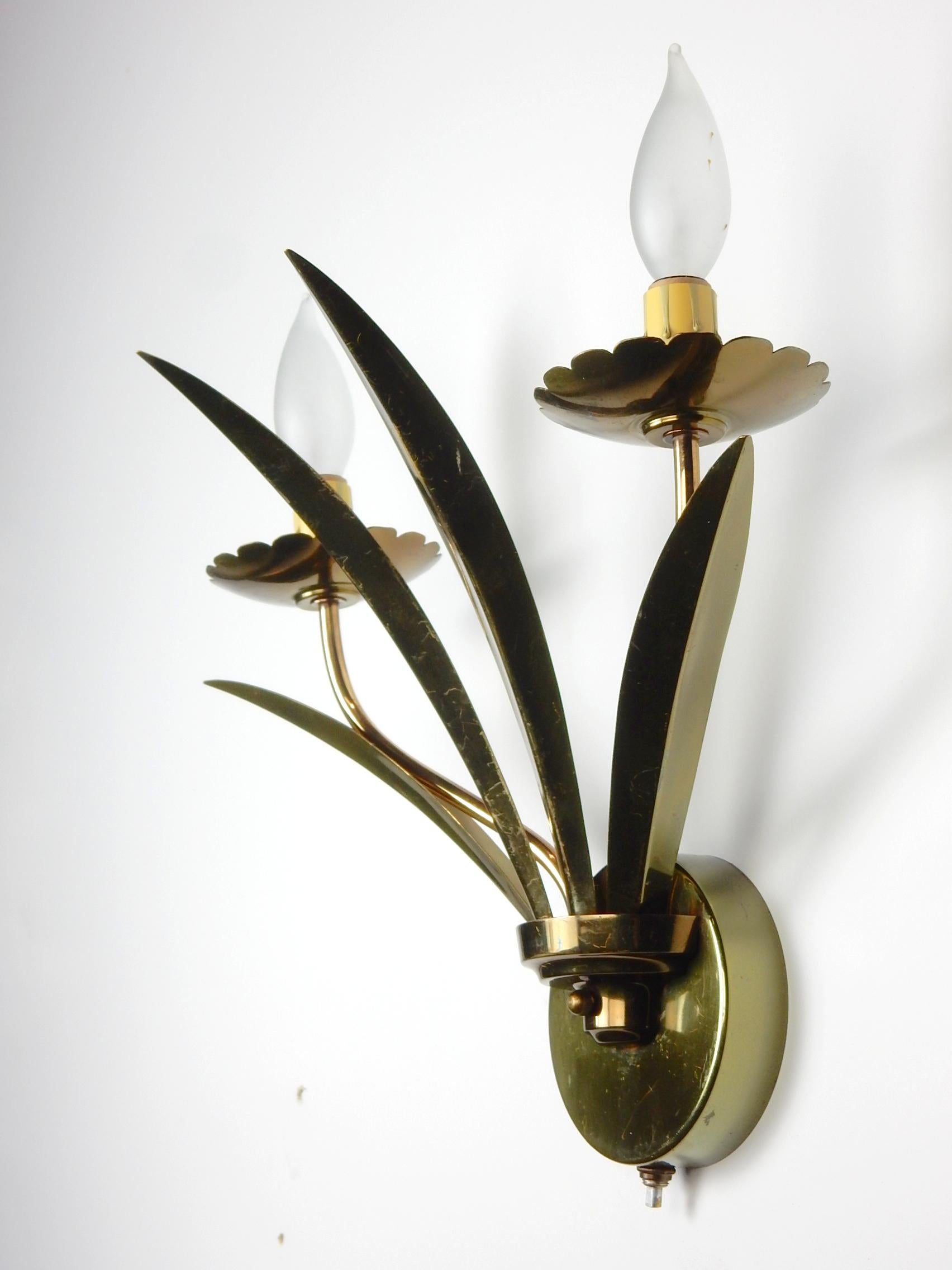 Fabulous pair of brass 4 petal, 2 flower, wall sconces circa 1950's.
Off/On switch at the bottom of wall mount. 
They fit to any standard electrical junction box(hardware included). 
 