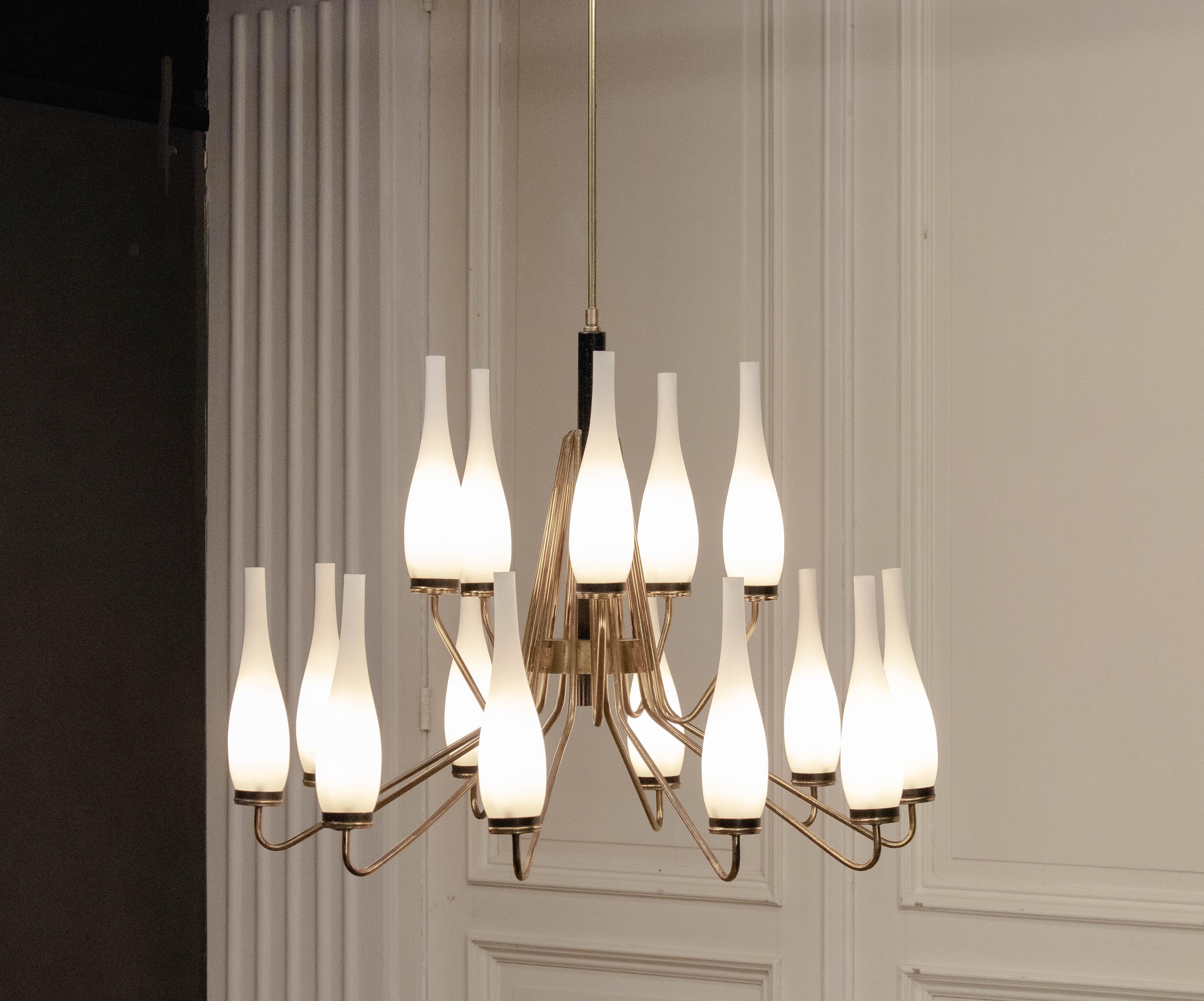 Striking 1950s brass chandelier by Stilnovo, Italy. This sophisticated mid-century design features fifteen gracefully arranged arms extending from a sculptural central column, creating an elegant balance of geometry and rhythm. Each arm supports a