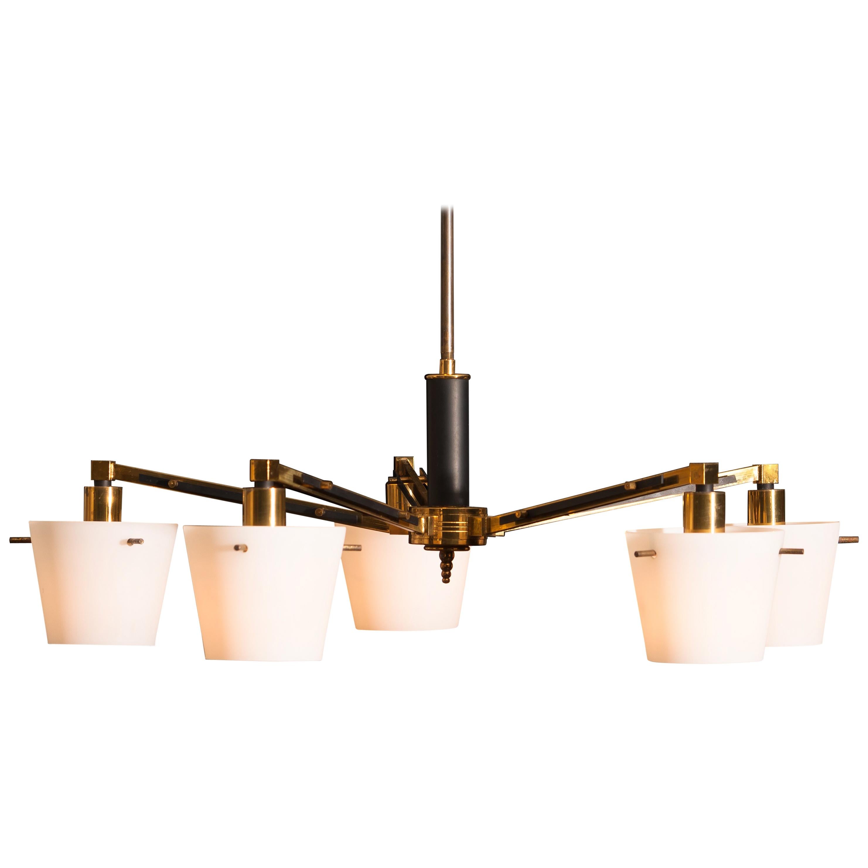 Beautiful and original midcentury chandelier with five frosted white glass shades on a brass frame by Stilnovo Italy. Period: 1950s. Five lights.
Technical 100% / E14 / 17.
The dimensions are ø of the fixture, 65 cm / 26 inch. Total height 70 cm /