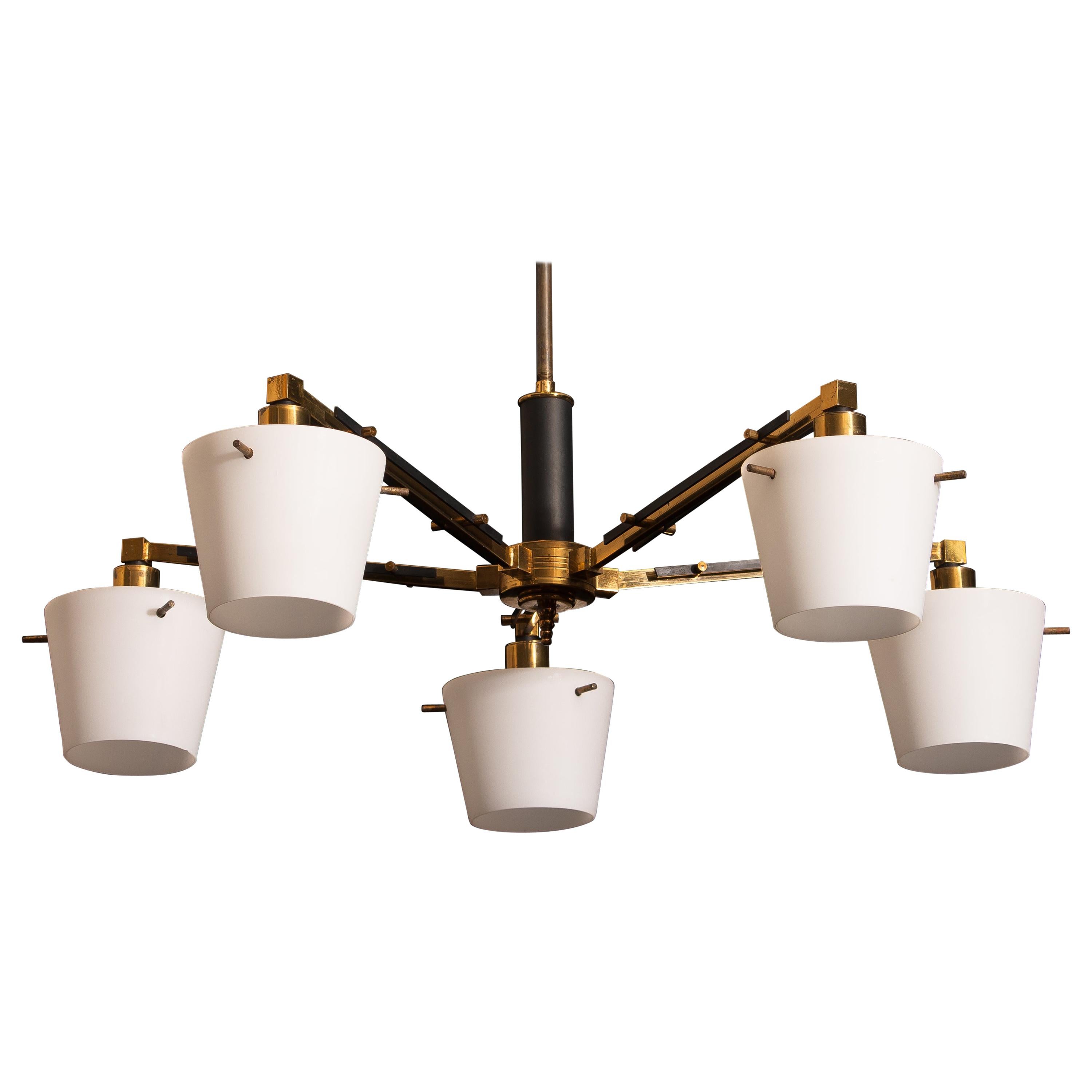 Beautiful and original midcentury chandelier with five frosted white glass shades on a brass frame by Stilnovo, Italy. Period: 1950s. Five-light.
Technical 100% / E14 / 17.
The dimensions are Ø of the fixture, 65 cm / 26 inch. Total height 70 cm /