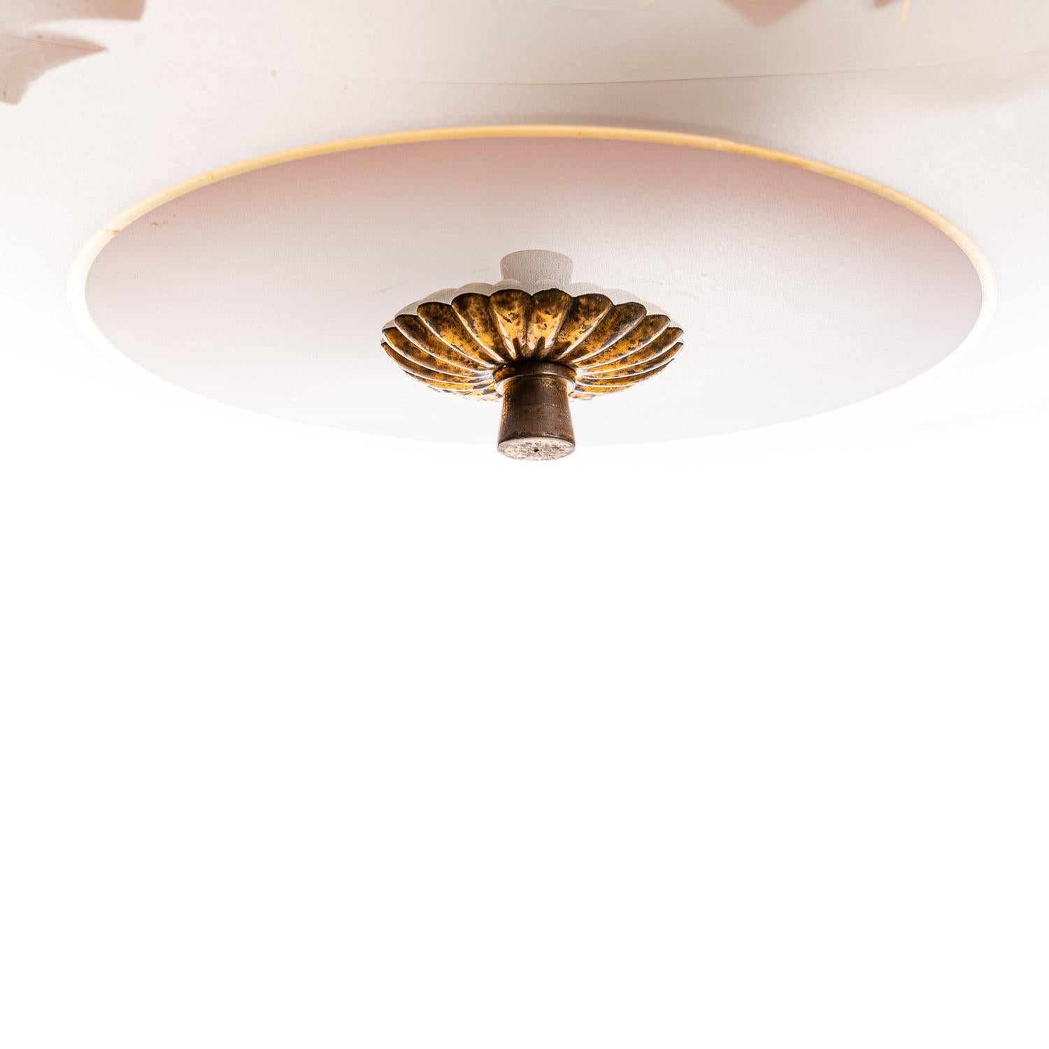 This elegant piece consisting of a brass frame and 2 unique frosted and satin glass reflector/saucers. 
The lower round curved glass reflector with a colorful pink floral motif mounts below a round satin glass reflector. Finished off with a brass