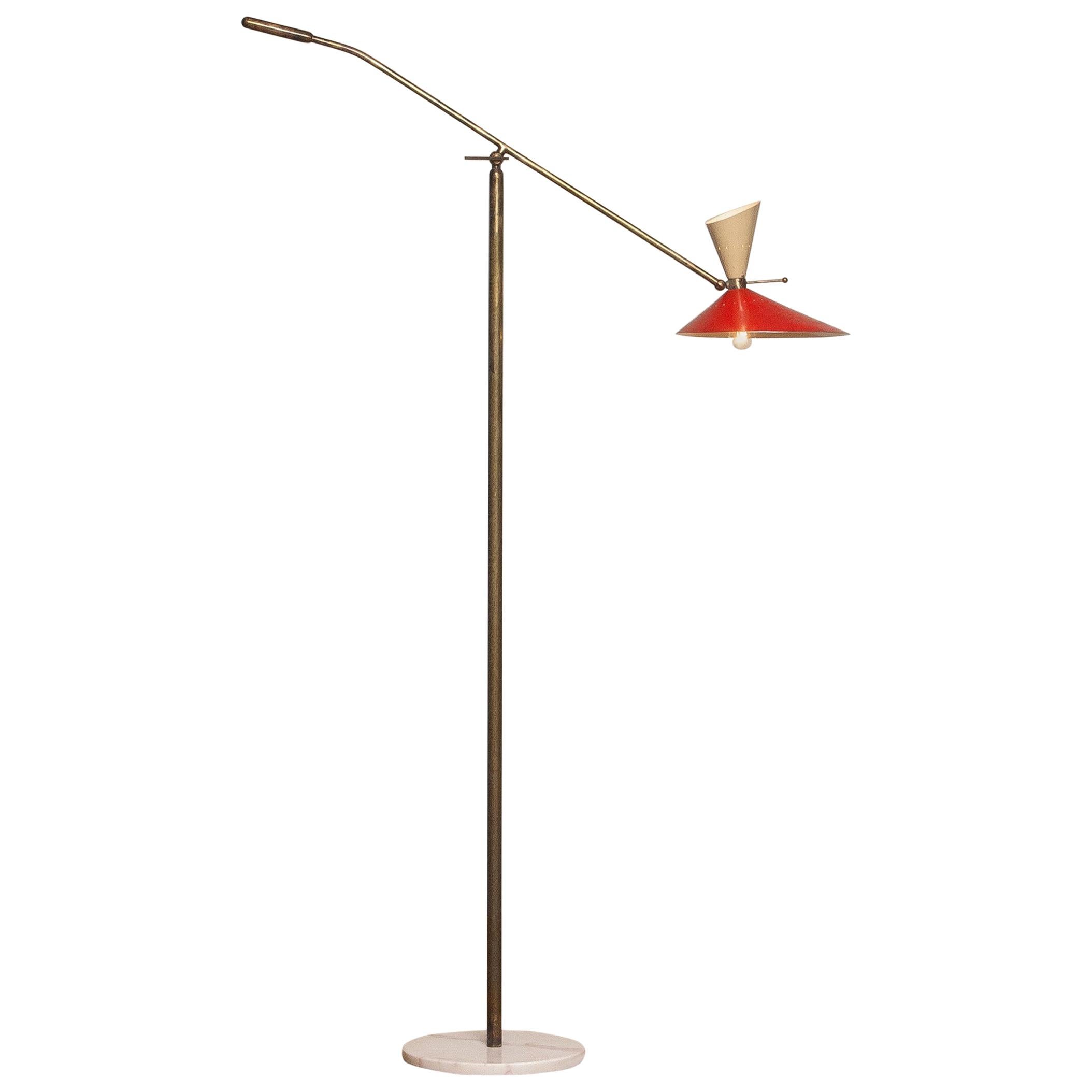 Absolutely stunning floor lamp with up and down lightning by Stilux Milano Italy in brass on a marble floor stand. The brass has a great patina true the years and in an overall good condition. Technically 100%. The upper light fitting is a E14 / E17