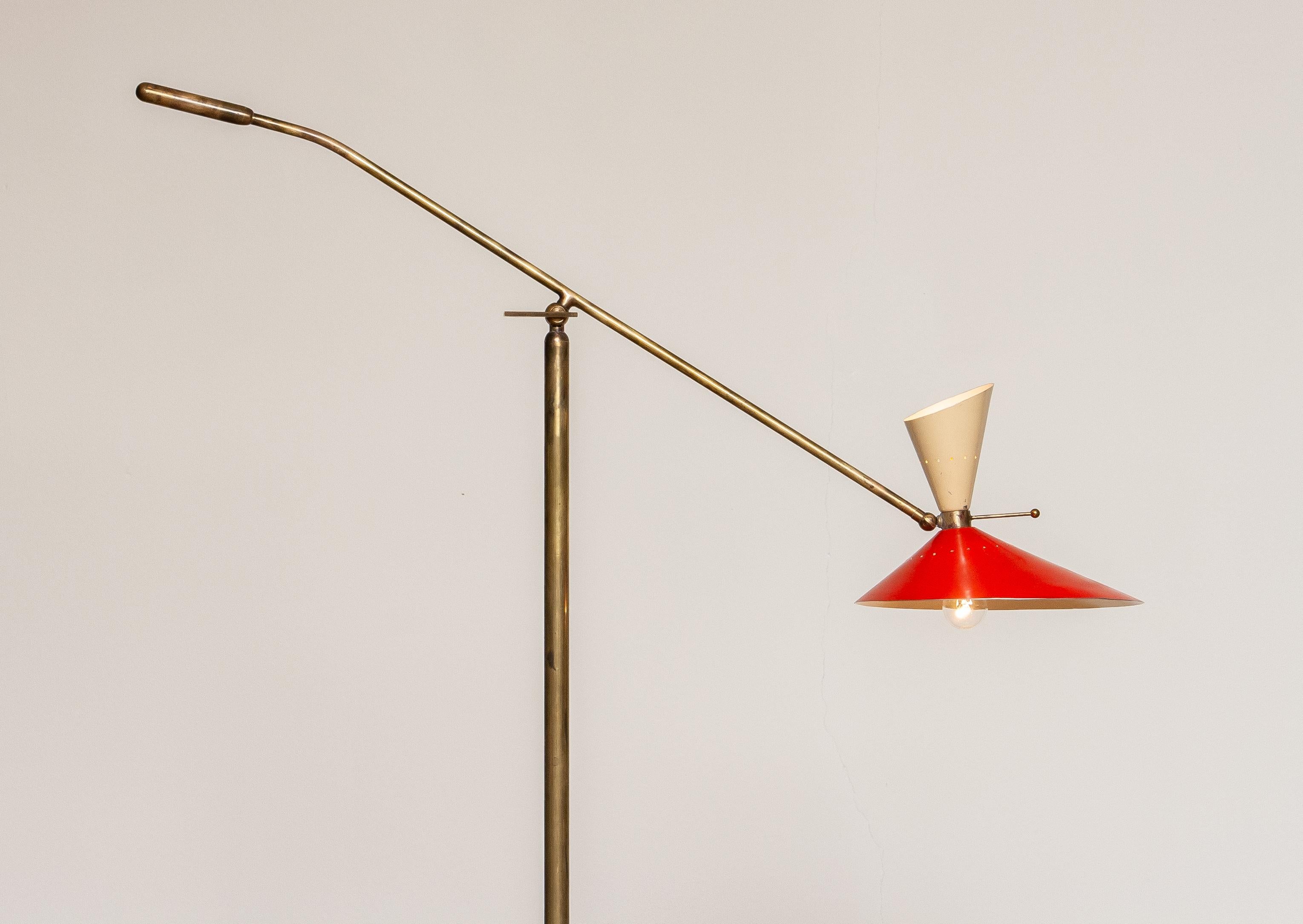 Absolutely stunning floor lamp with up and down lightning by Stilux Milano Italy in brass on a marble floor stand. The brass has a great patina true the years and in an overall good condition. Technically 100%. The upper light fitting is a E14 / E17