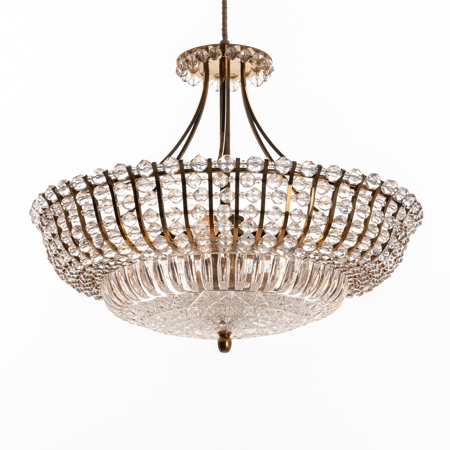 A Stunning midcentury design manufactured around 1950. It is made of brass, lucite and hand-cut crystal dish. Briljant beading work in acrylic.