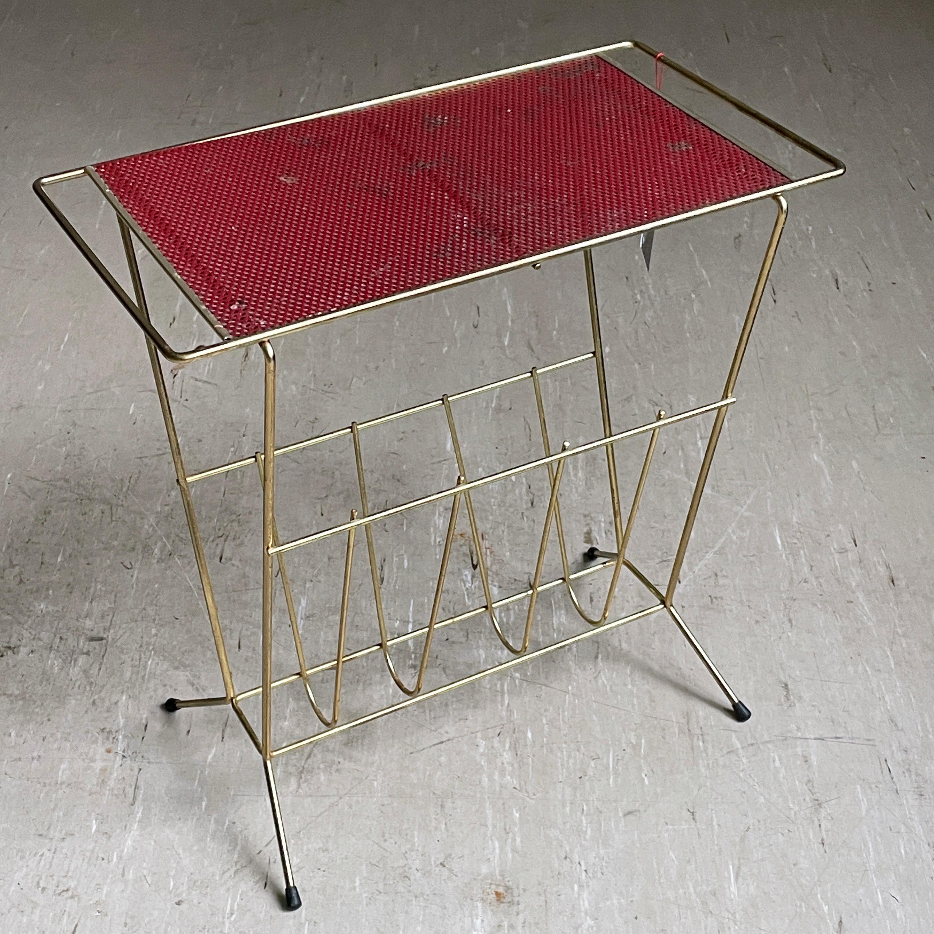 1950’s Magazine / Newspaper Rack
Stylish Mid Century design with perforated sheet metal tabletop and gold tubular metal frame. Compliments any interior space. For magazine / newspaper storage at home or a coffee shop, waiting room