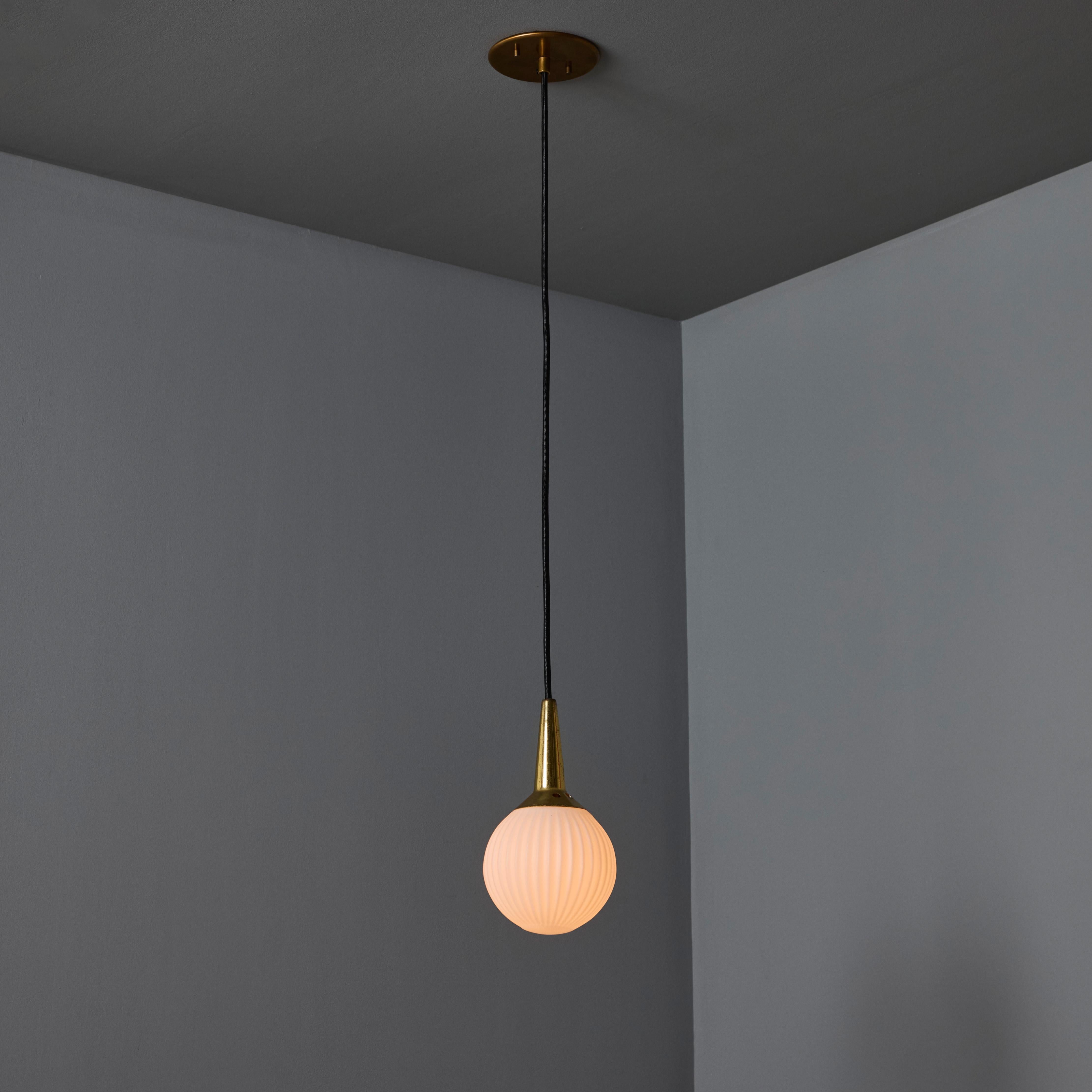 1950s Brass & Opaline Glass Pendant Attributed to Stilnovo. Executed in sculptural round opaline glass with brass hardware. A highly refined ceiling lamp light of attractive scale and incomparable refinement. Unmarked.

Stilnovo was one of the most