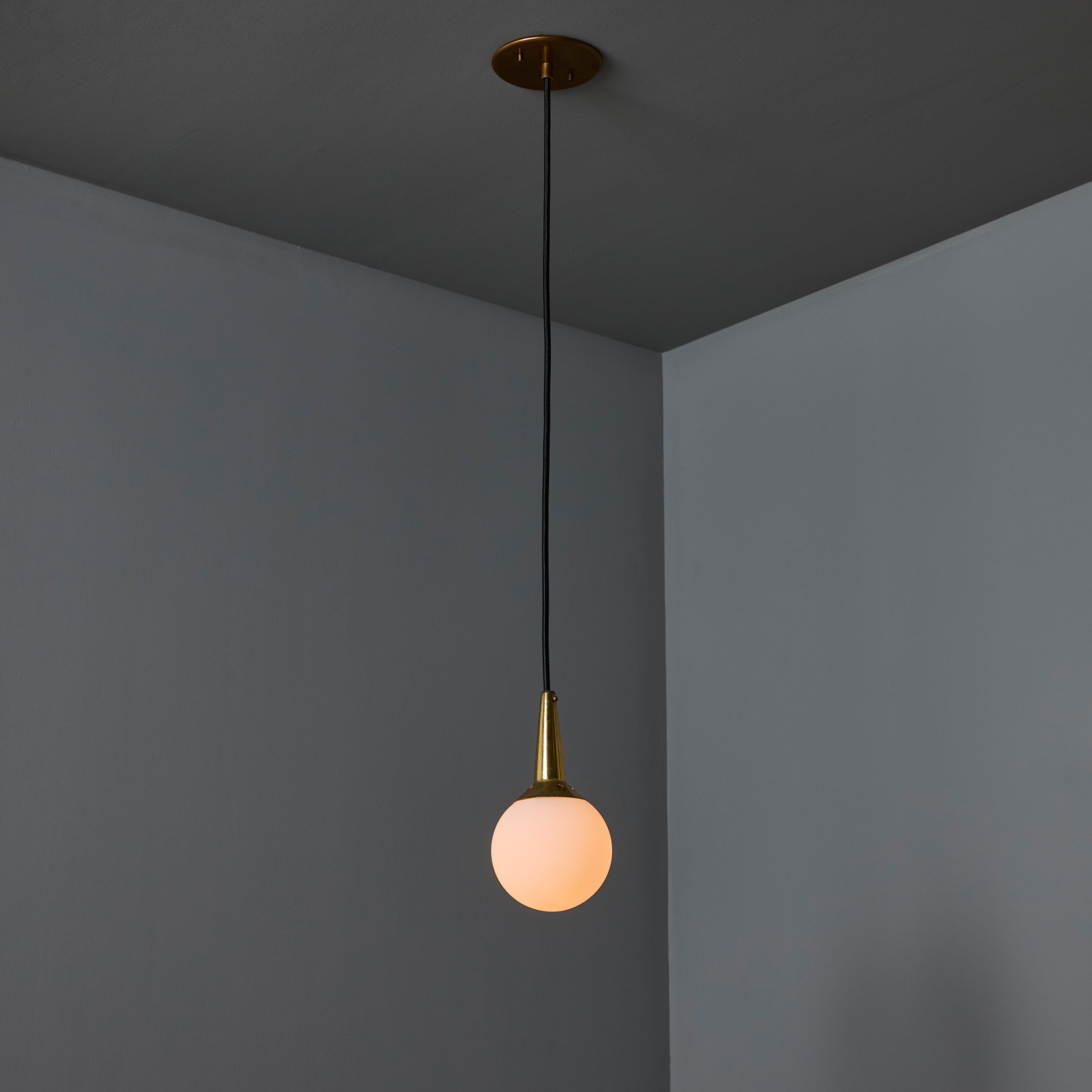 1950s Brass & Opaline Glass Pendant Attributed to Stilnovo. Executed in sculptural round opaline glass with brass hardware. A highly refined ceiling lamp light of attractive scale and incomparable refinement. Unmarked.

Stilnovo was one of the most