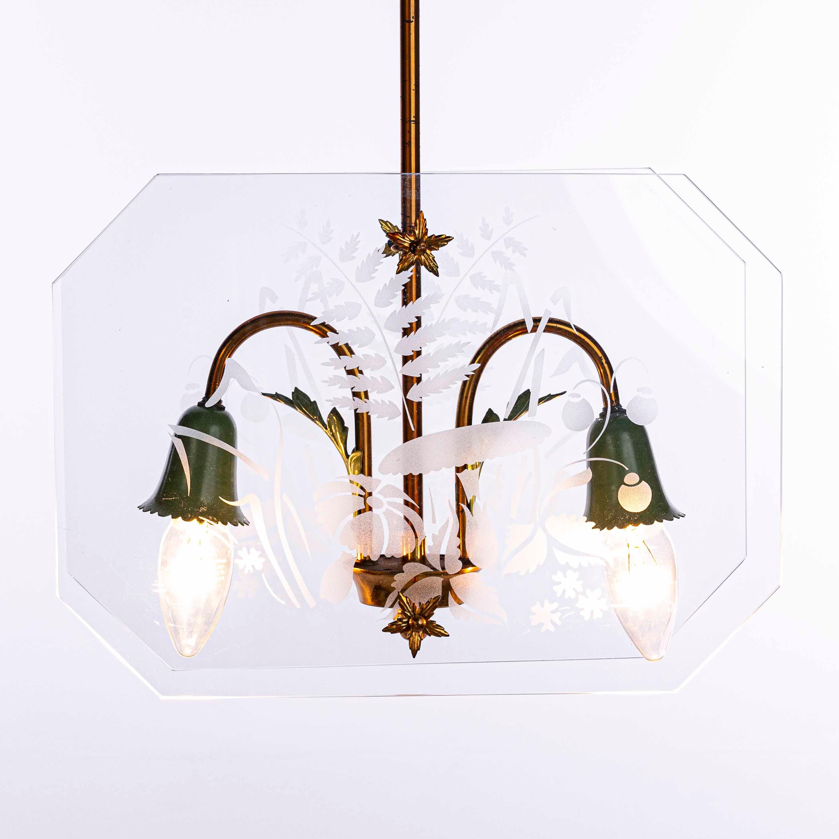 Cute two-light lantern in style of Fontana Arte. Consists of two etched glass panels with a flower pattern, a brass frame and green colored lamp E14 socket.
Measures: Glass panel 33cm width and 24 cm height. Minor scratches on the panels not so to
