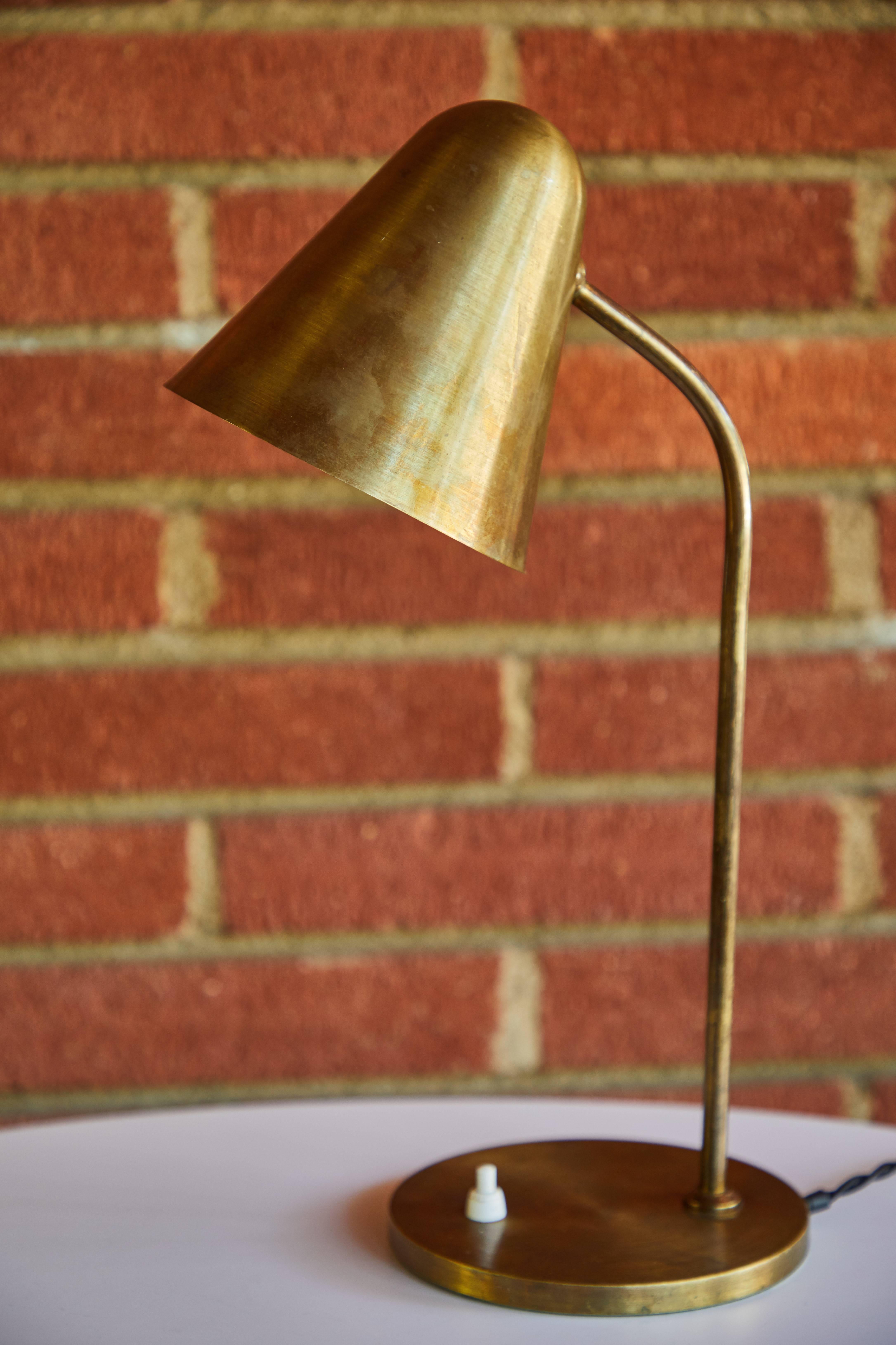 1950s brass table lamp attributed to Jacques Biny. An exceptionally clean and simple design executed in patinated brass with white painted inner shade. Quintessentially midcentury French in its conception and execution attributed to the incomparable