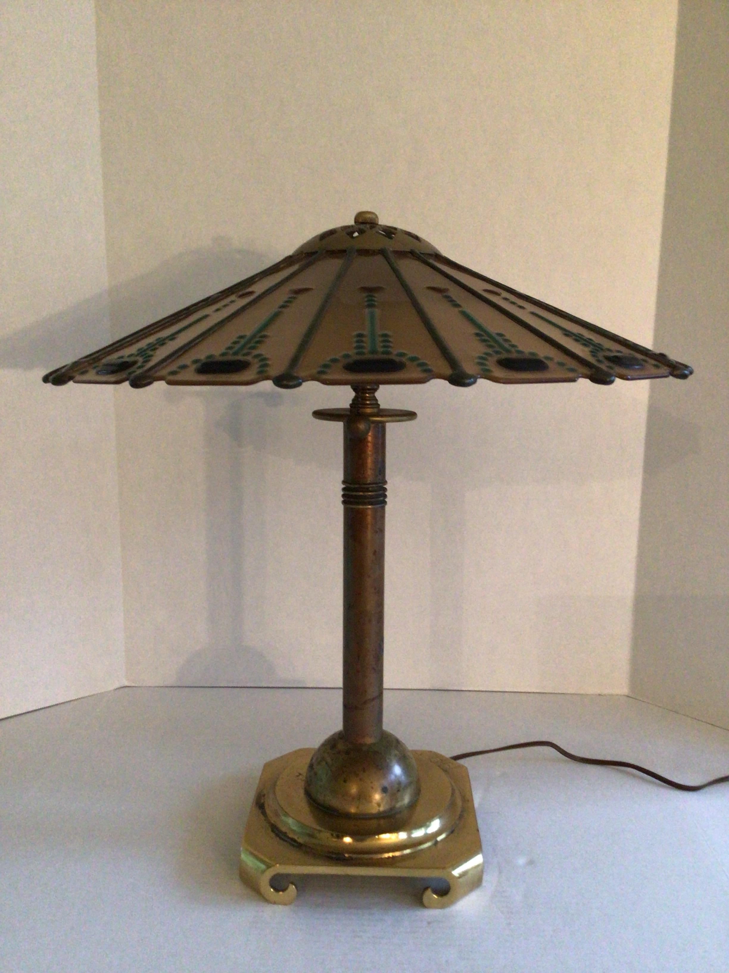 Lampe de table en laiton des années 1950 avec abat-jour en laiton et verre décoratif
La lampe est dotée d'une base en laiton
L'abat-jour comporte des tiges en laiton qui divisent les sections en verre taillé avec des embellissements en verre coloré