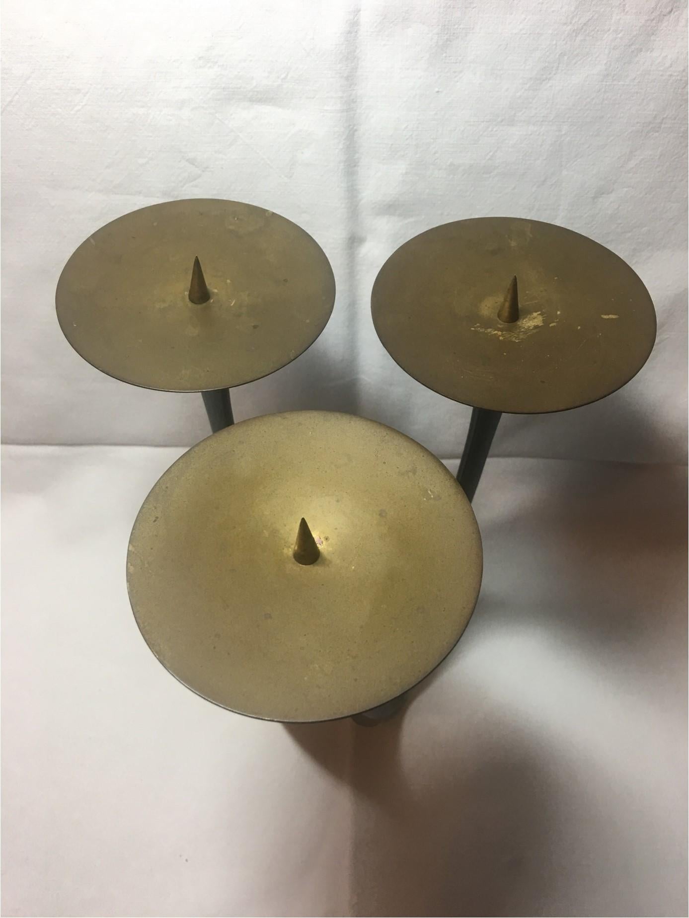 A 1950s era black and brass candleholder designed by Klaus Ullrich for Faber & Schumacher. A beautiful natural Patina has formed over the decades. The candle drip holders radius is 4 inches.
A lovely piece for any room.