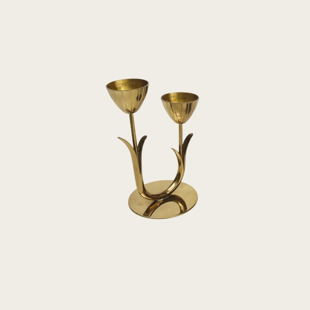 1950s, Sweden. Candlestick holders crafted in the shape of flower buds are in excellent condition and feature the Ystad Metall stamp on the bottom. Designed by Gunnar Ander (1927-2002), a prominent Swedish industrial designer, his collaboration with