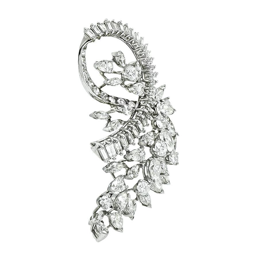 This is an elegant platinum pin from the 1950s. The pin is set with sparkling marquise, pear, round and baguette cut diamonds that weigh approximately 6.00ct. The color of the diamonds is G with VS clarity. The pin measures 48mm by 26mm and weighs
