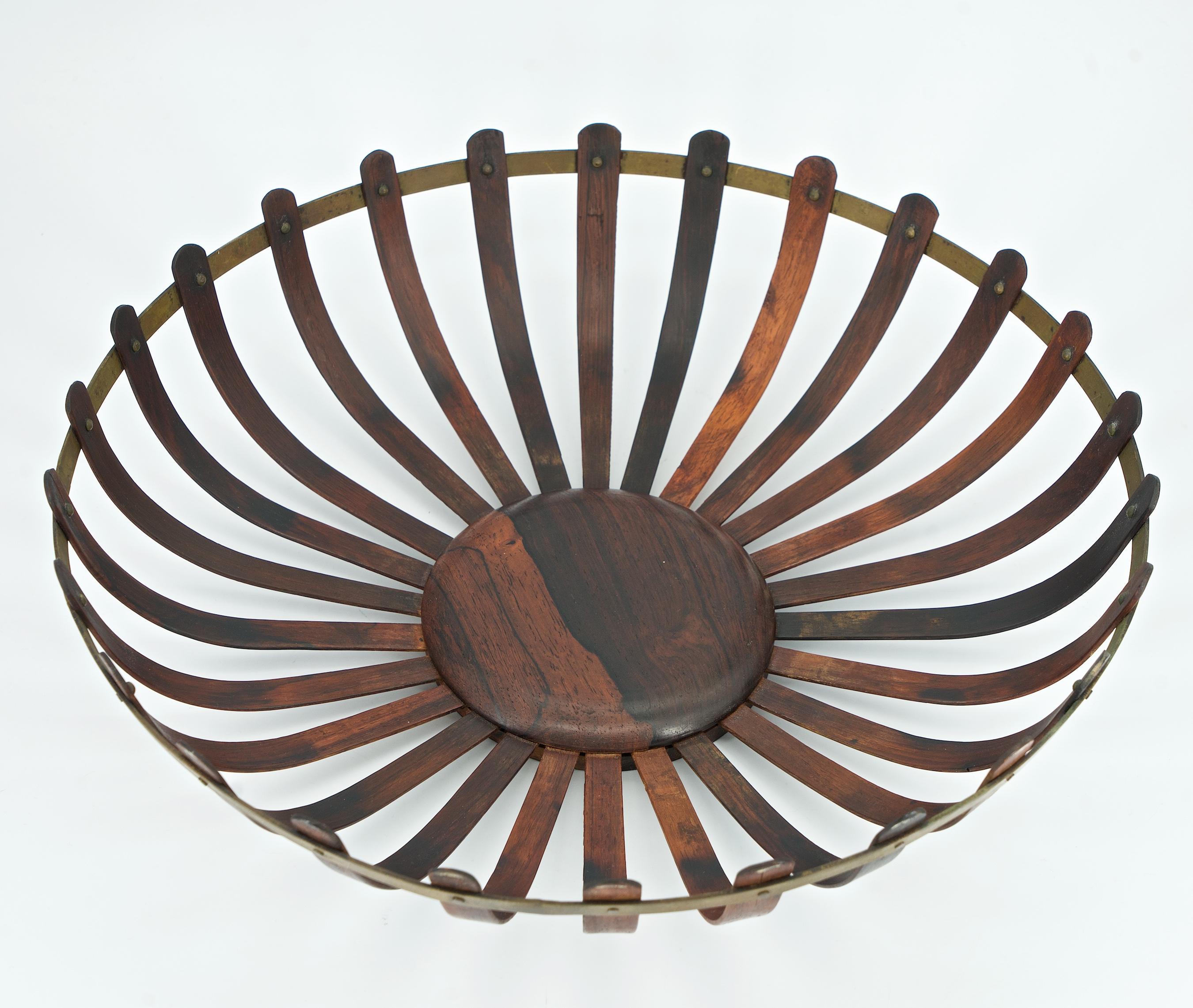 Made in Brazil, a hand-crafted footed centerpiece sculpture, truly an mid-century masterpiece. A fragile, brass belted, curved Jacaranda (Brazilian Rosewood) slat design. A rare find, cleaned and re-oiled. In the manner of Oscar Niemeyer or Joaquim