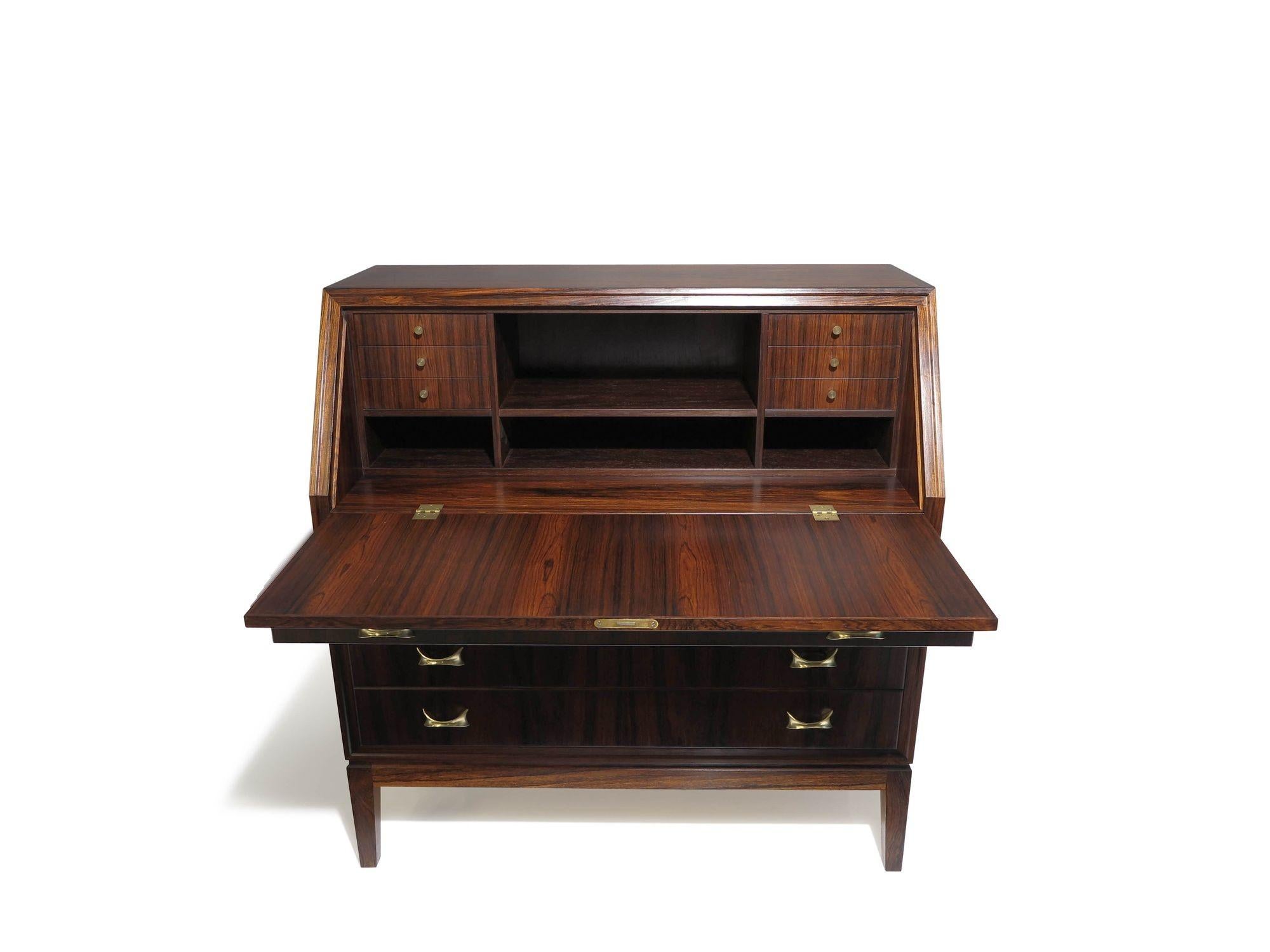 High-quality Brazilian rosewood secretary desk, 1955, Denmark. The secretary desk is finely crafted of stunning Brazilian Rosewood with dark grains and dynamic book-matched patterns across the front of drawers and sides. The secretary features four