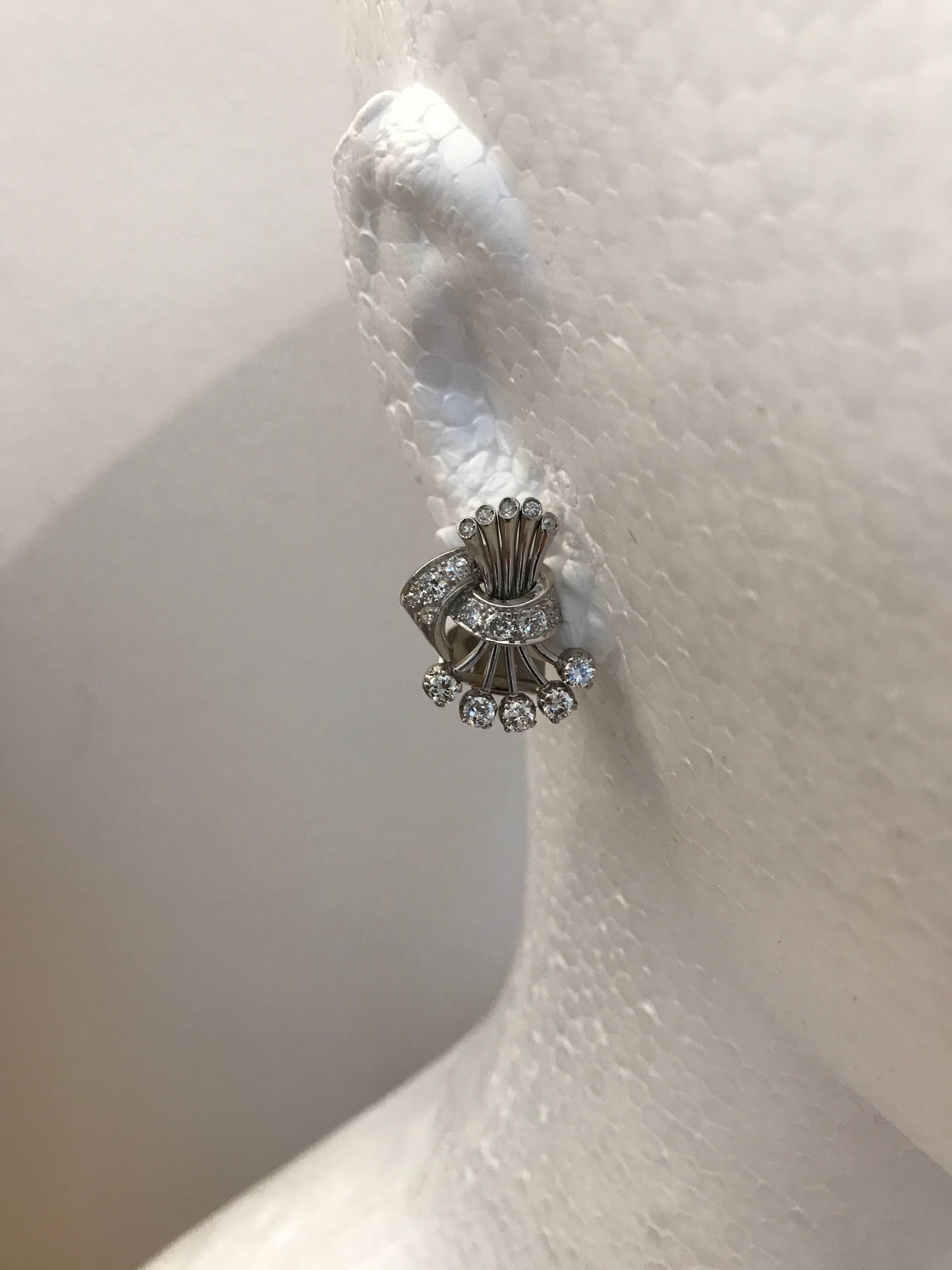 An extremely chic pair of brilliant cut diamond earrings set in platinum and 18ct white gold, made circa 1950

Weight of diamonds 2 carats approximately

Length of earrings 2cms approximately