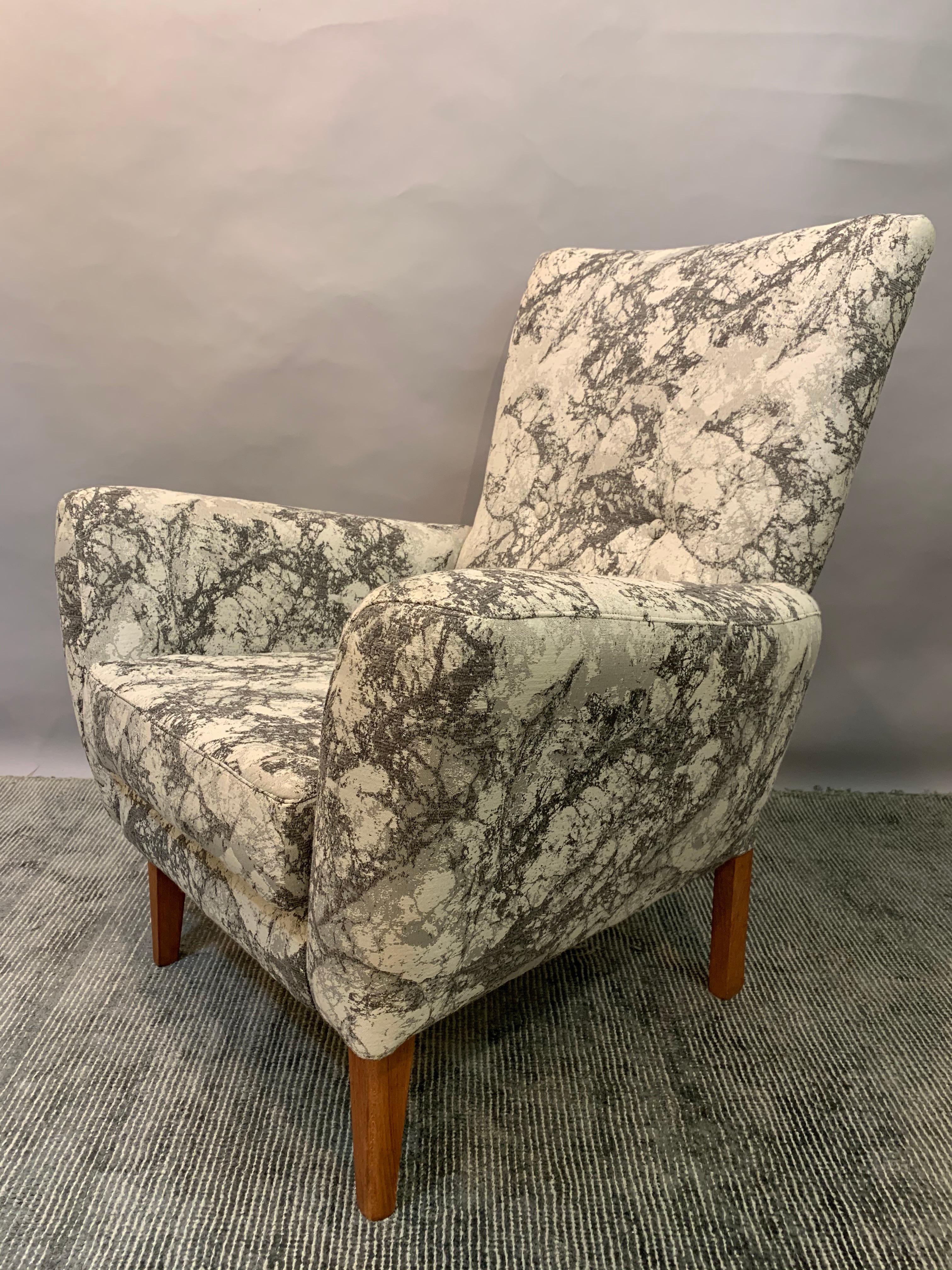 An elegant 1950s British made armchair newly reupholstered in a light and dark grey marble effect fabric. The chair sits on four polished and varnished square legs. In very good vintage condition. Perfect for every room of the house as a small,