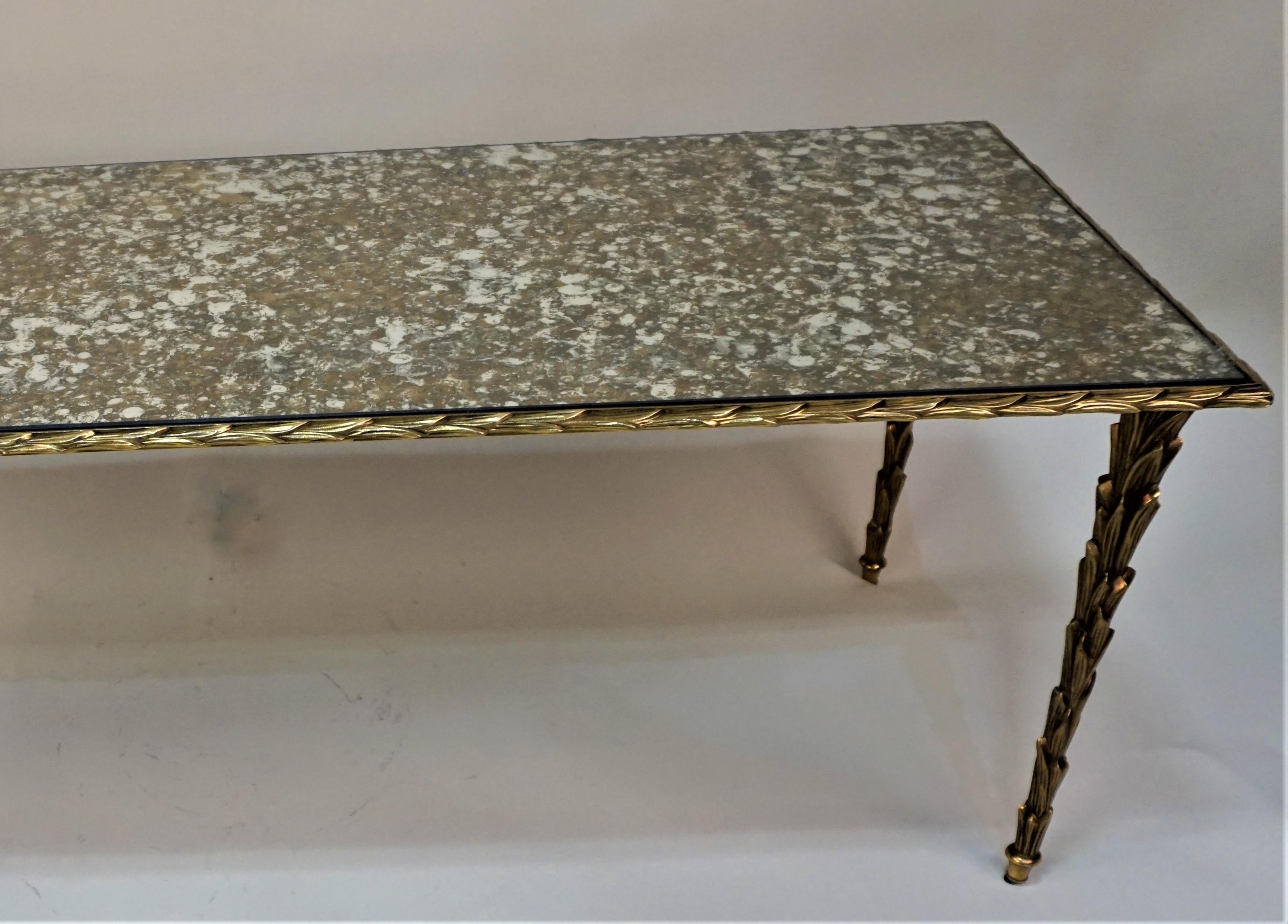 Beautiful palm tree design bronze coffee table with bronze, brown and silver mirror top.