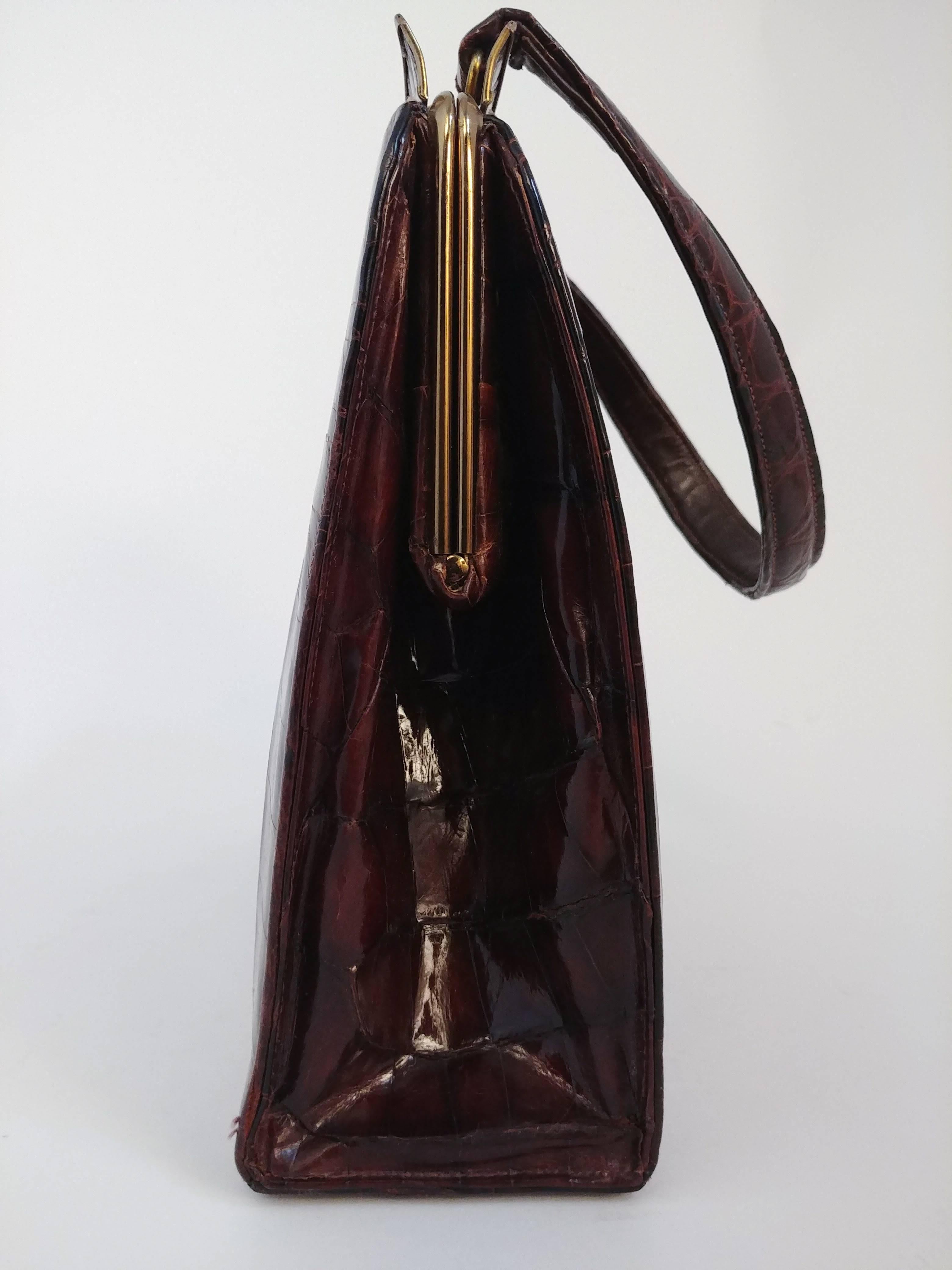 1950s Brown Alligator Handbag. Gold toned hardware and tan leather lining. Comes with small mirror. 