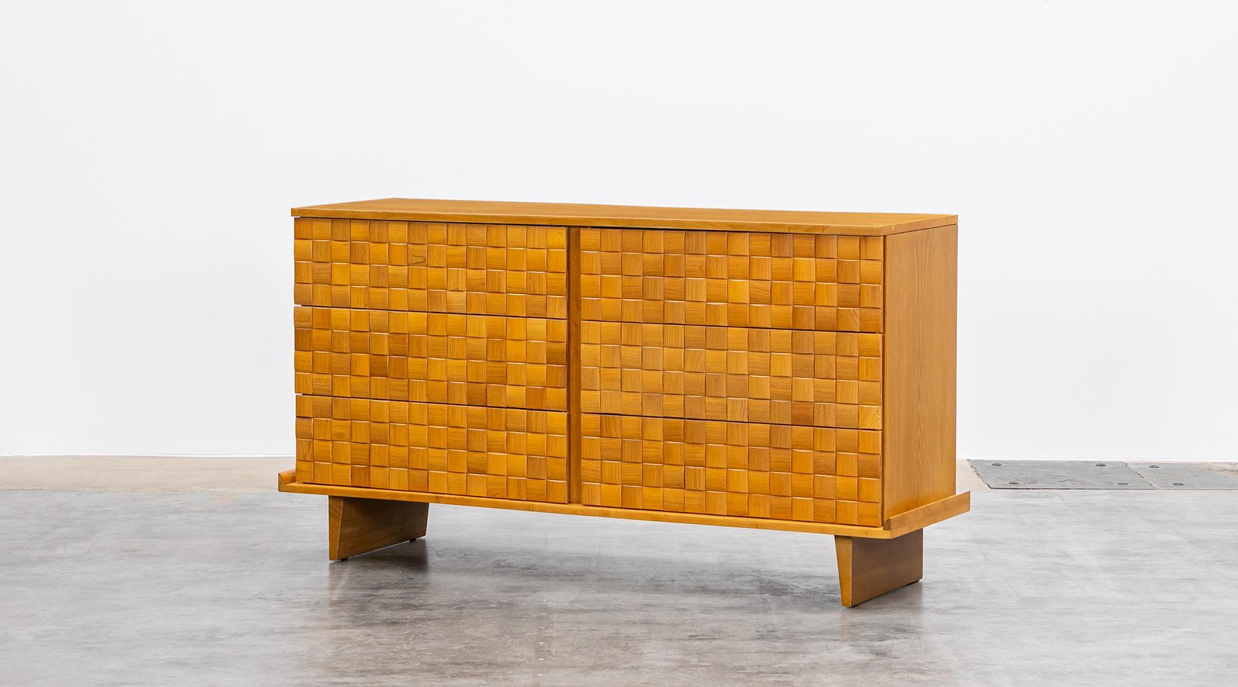 Handsome ash cabinet designed by Paul Laszlo features six of his basket weave drawer fronts and modern shaped legs. The sideboard comes in very good original condition, professionally reworked by our workshop. Manufactured by Brown Saltman.

The