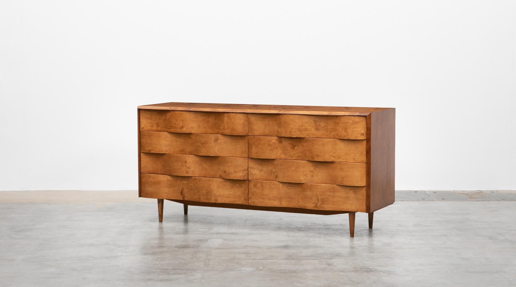 Cabinet in birch, eight drawers, Edmund Spence, Sweden, 1950.

The exceptionally beautiful birch sideboard designed by Edmund Spence is characterised by its wave-shaped drawer fronts and modern legs. The sideboard is delivered in very good original