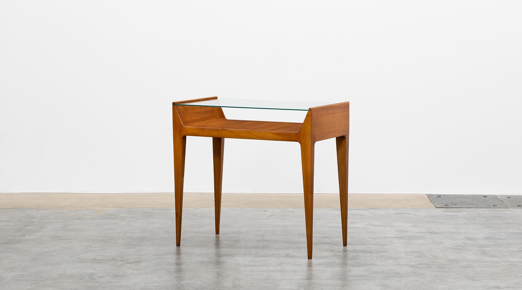 Console, cherrywood, polished glass, Gio Ponti, Italy, 1955.

Beautiful console in cherrywood, designed by the famous Gio Ponti. The top is made of polished glass and offers a storage space underneath. The console has an unusual height, which only