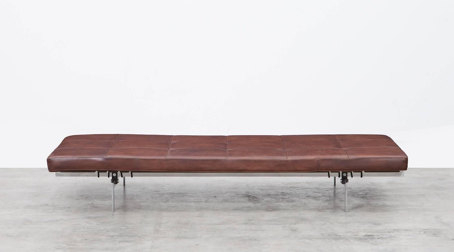 Classic daybed designed by Poul Kjaerholm. The dark brown thick leather tufted cushion fits perfectly on the chromium-plated steel frame. All-over it comes in perfect original condition. Manufactured by E. Kold Christensen.

Legendary Danish