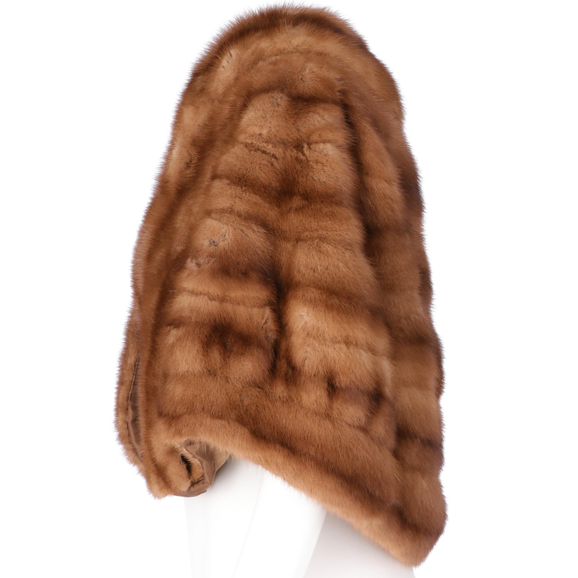 Soft brown mink cape, shawl collar, welt pockets, front closure with hook, half-length, round hem. Brown fabric lining with embroidered letters.

Please note this item cannot be shipped outside the European Union.

Years: 50s

Made in England

Size: