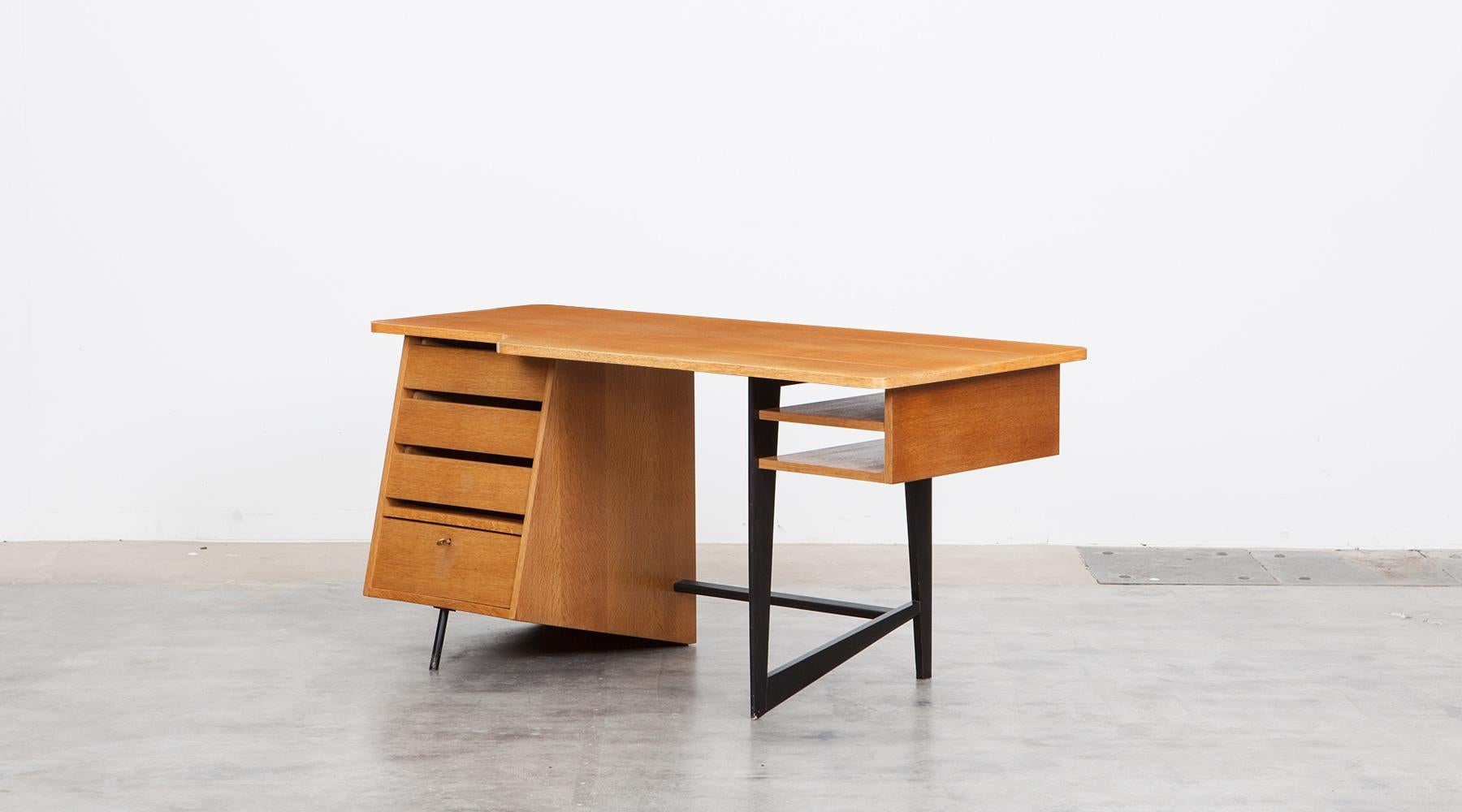 Desk in oak with leather food rest by Claude Vassal, France, 1955.

The beautifully shaped desk designed by Claude Vassal comes with four drawers on one side and two side compartments on the other. A drawer is to lock, the key is available. The